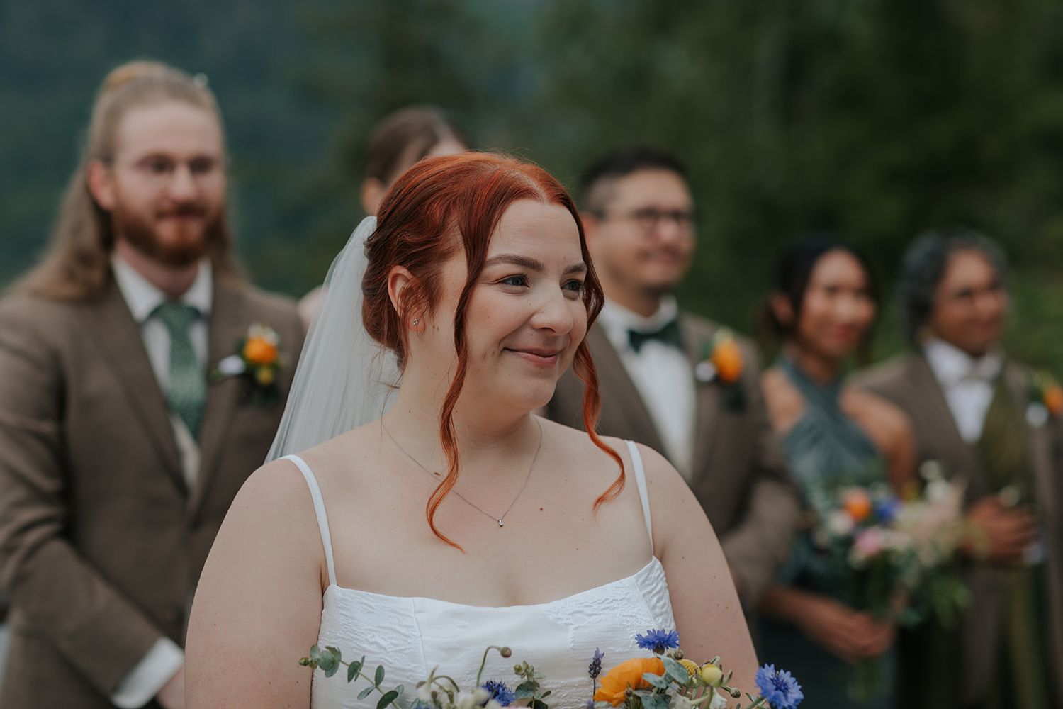Candid moments between wedding party members during outdoor celebration.