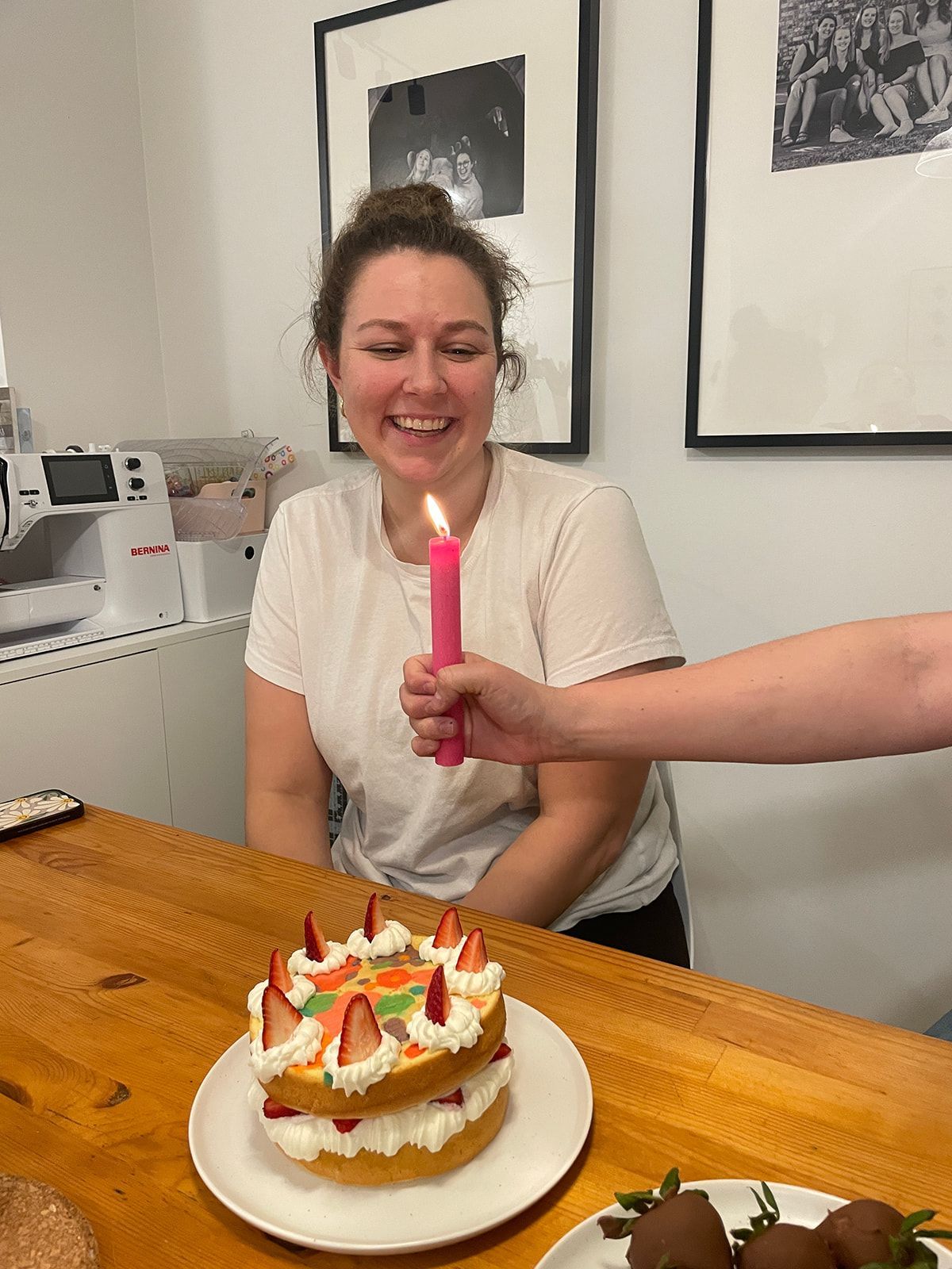 Birthday celebration with a decorated cake on a wooden table.