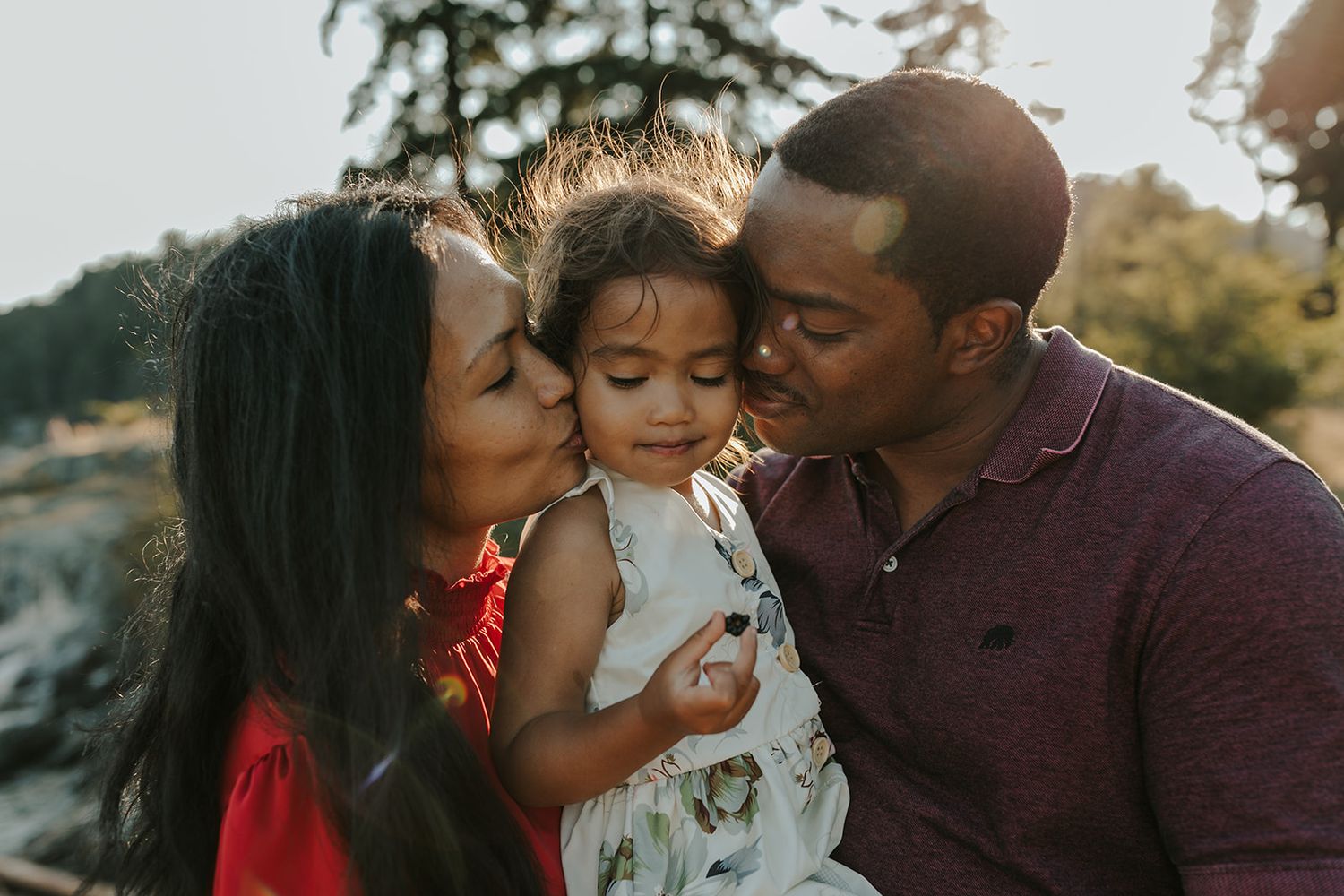 Family sharing loving moments together during sunset photo session.