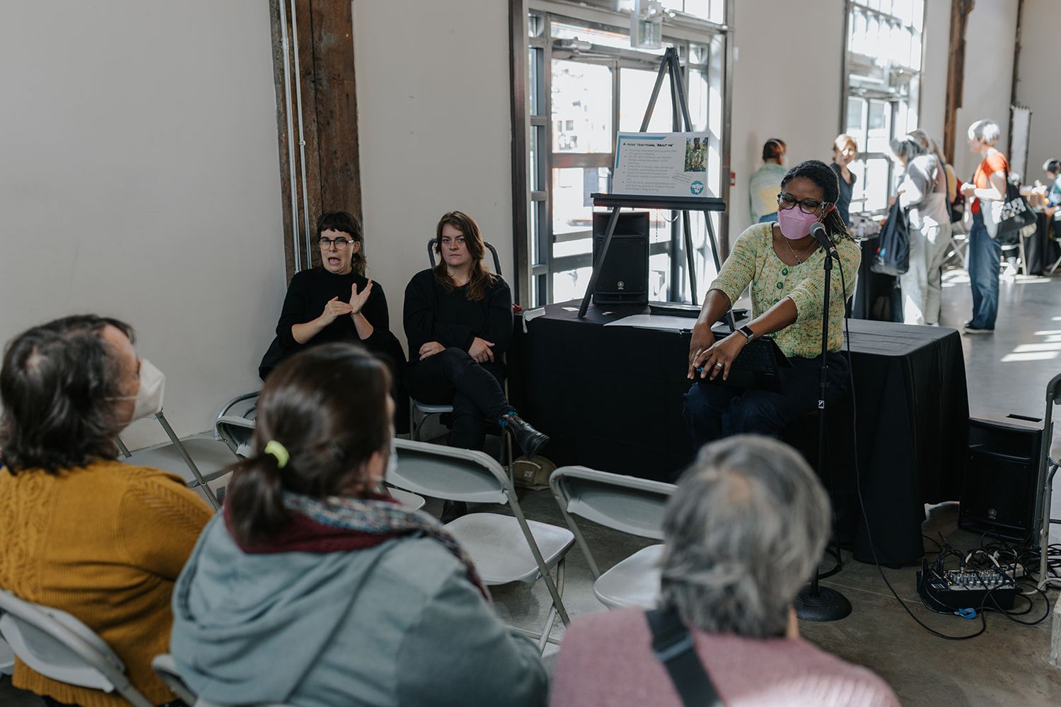 People gathered in a bright indoor space for a community event or workshop.