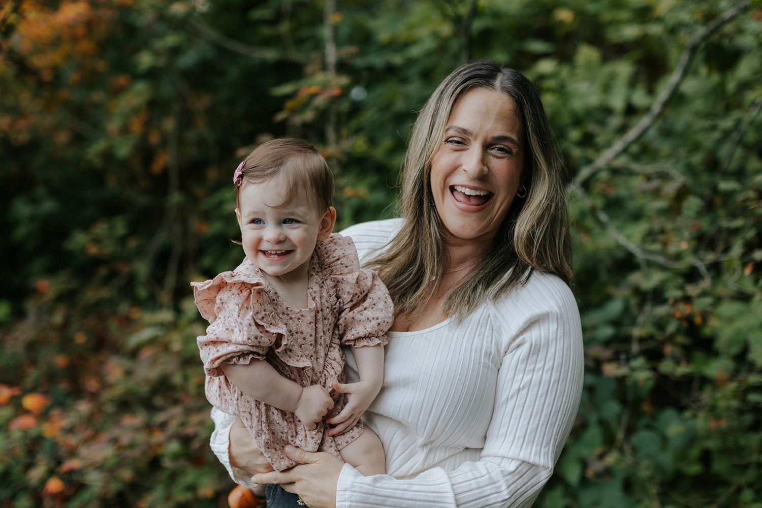 Candid moments of joy and laughter captured in autumn outdoor setting.