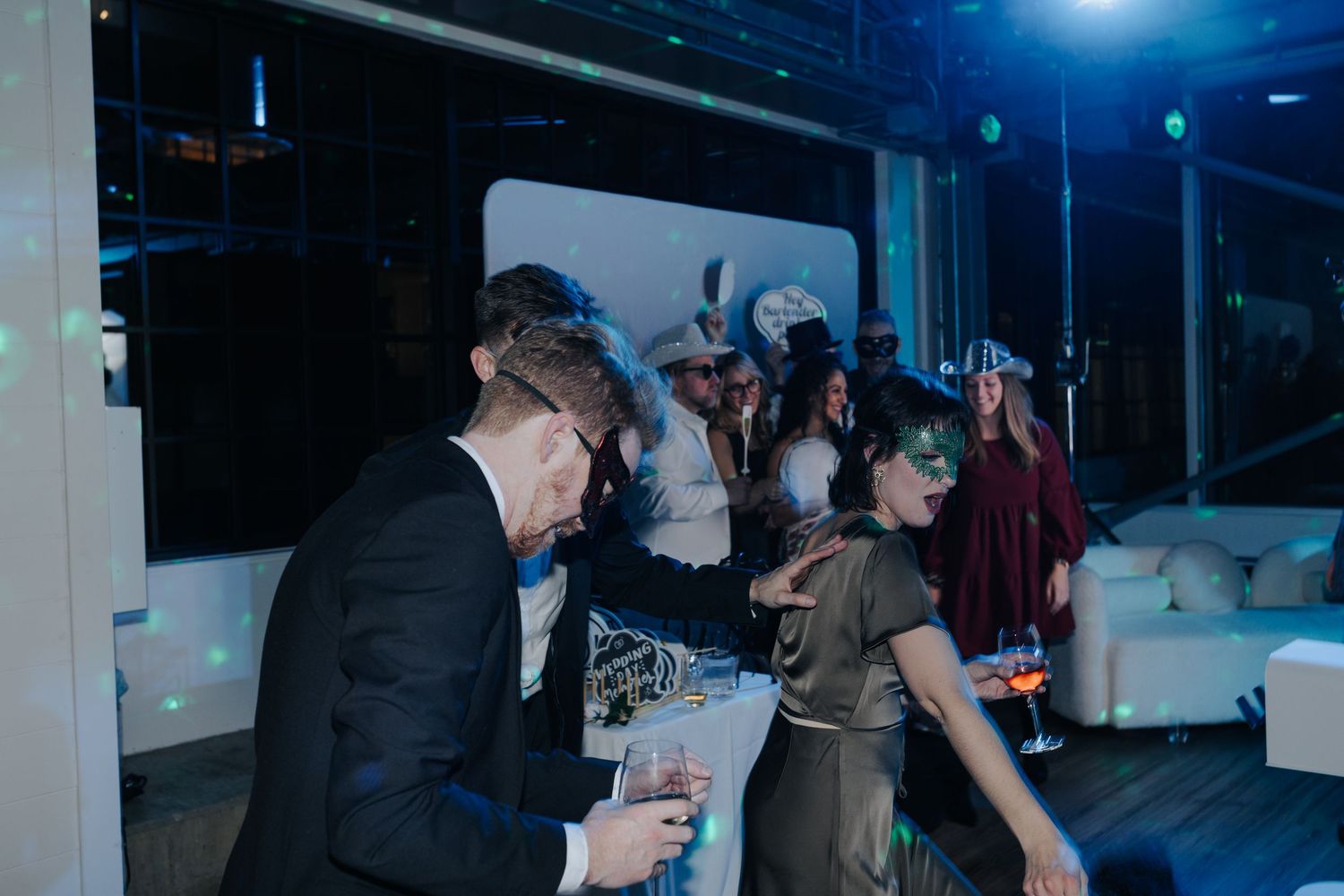 Wedding reception dance party with blue lighting and guests enjoying the celebration.