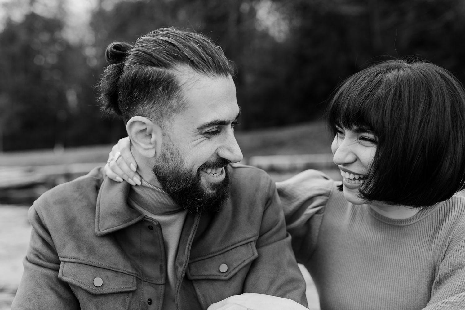 Black and white photos capture tender moments between a couple during an intimate photoshoot.
