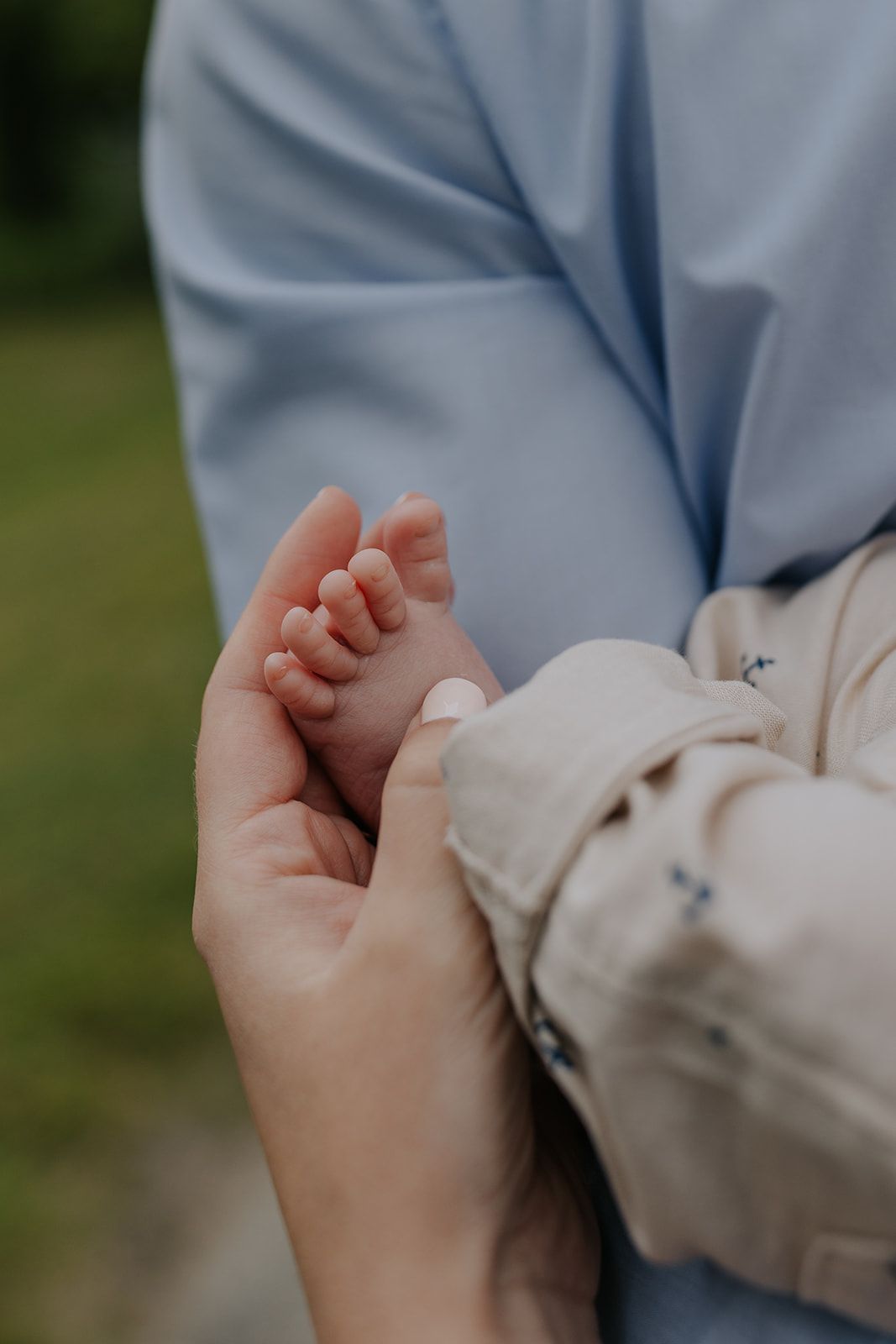Close-up detail of gentle hands holding in soft natural light.