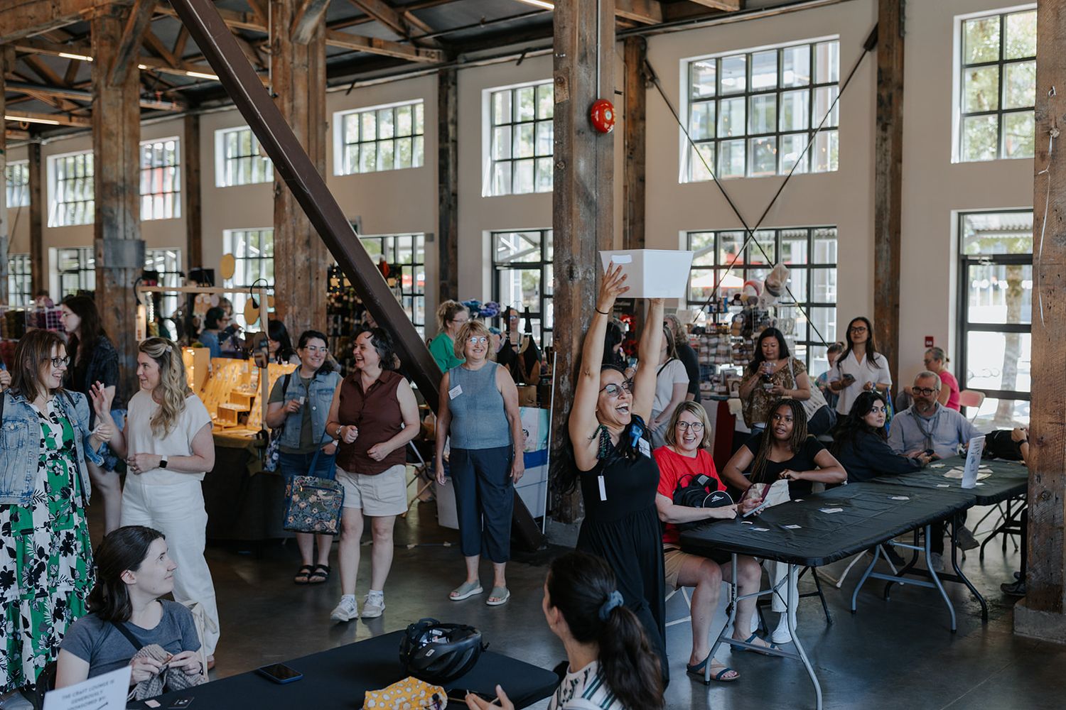 Wide shot of an industrial-style event space filled with attendees.