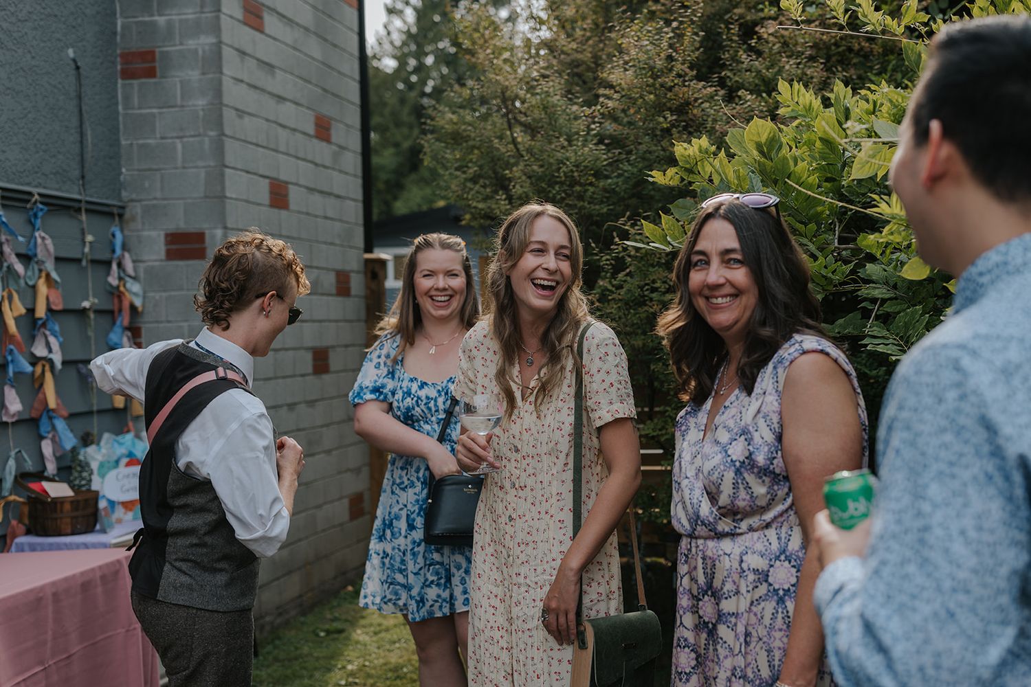 Guests mingling and laughing during an outdoor wedding reception.