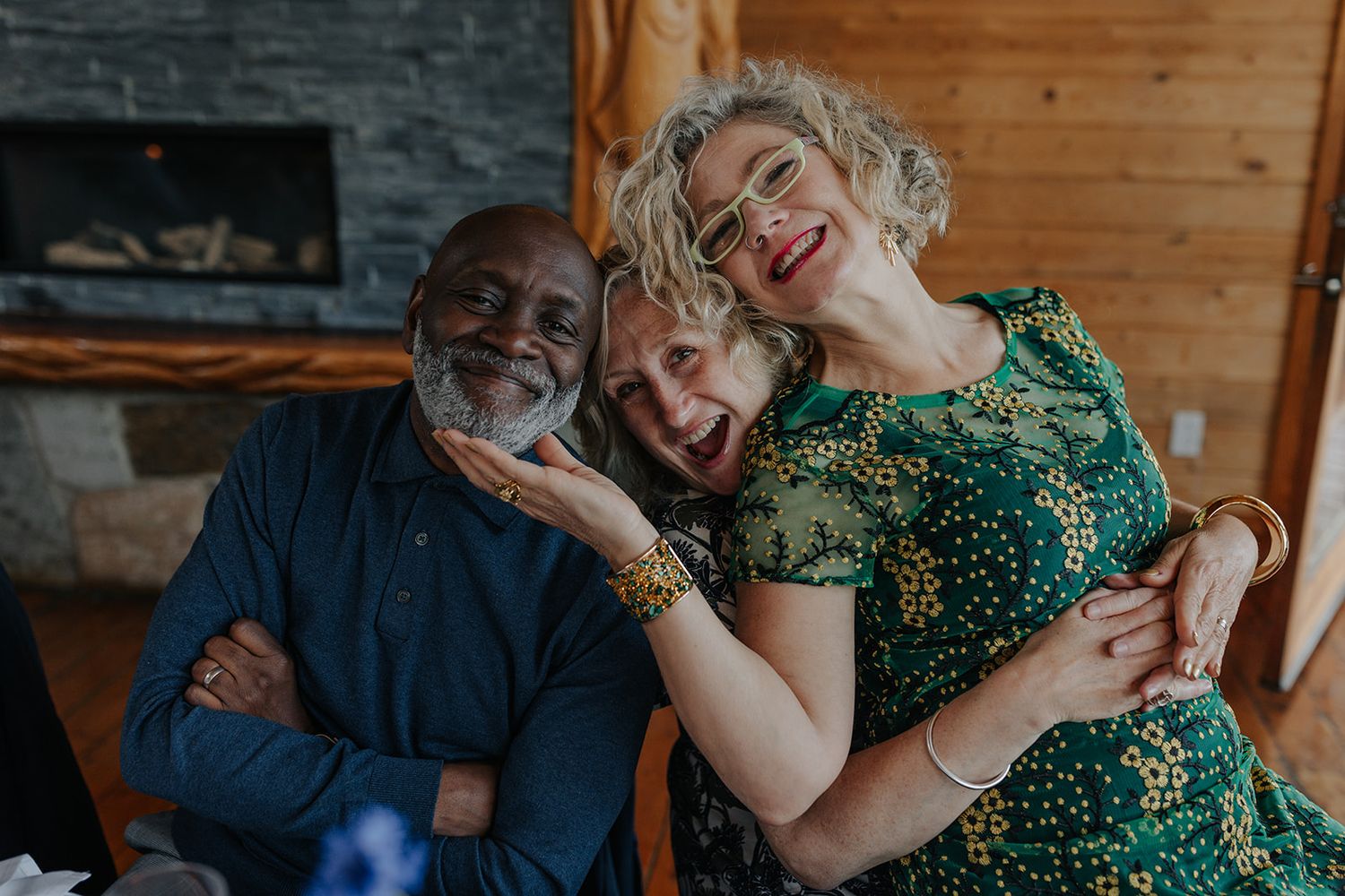 Candid moments captured during a wedding reception in a rustic wooden venue.