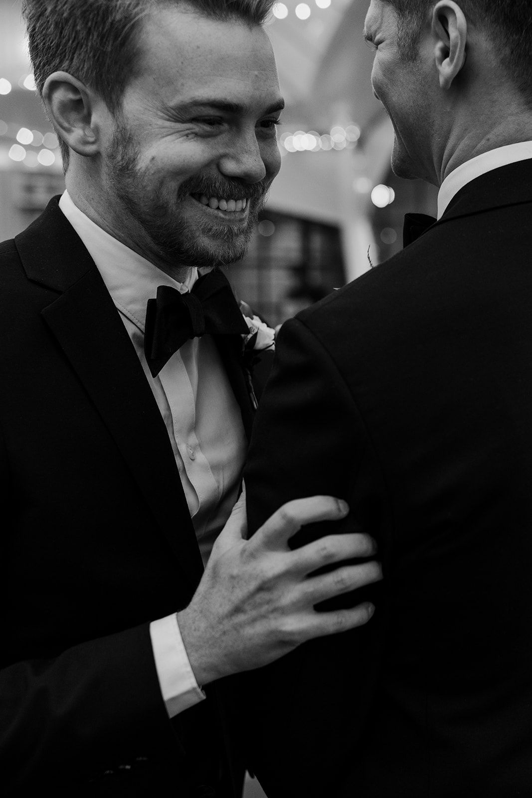 Intimate black and white moment captured during wedding celebration.
