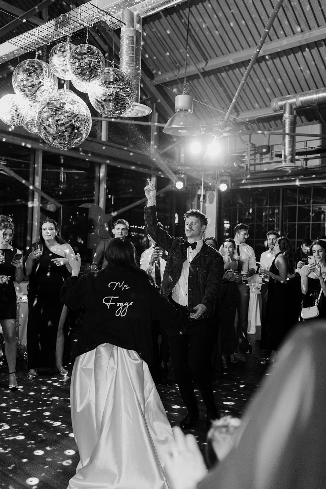 Wedding reception dance floor with disco balls and party lights creating a festive atmosphere.
