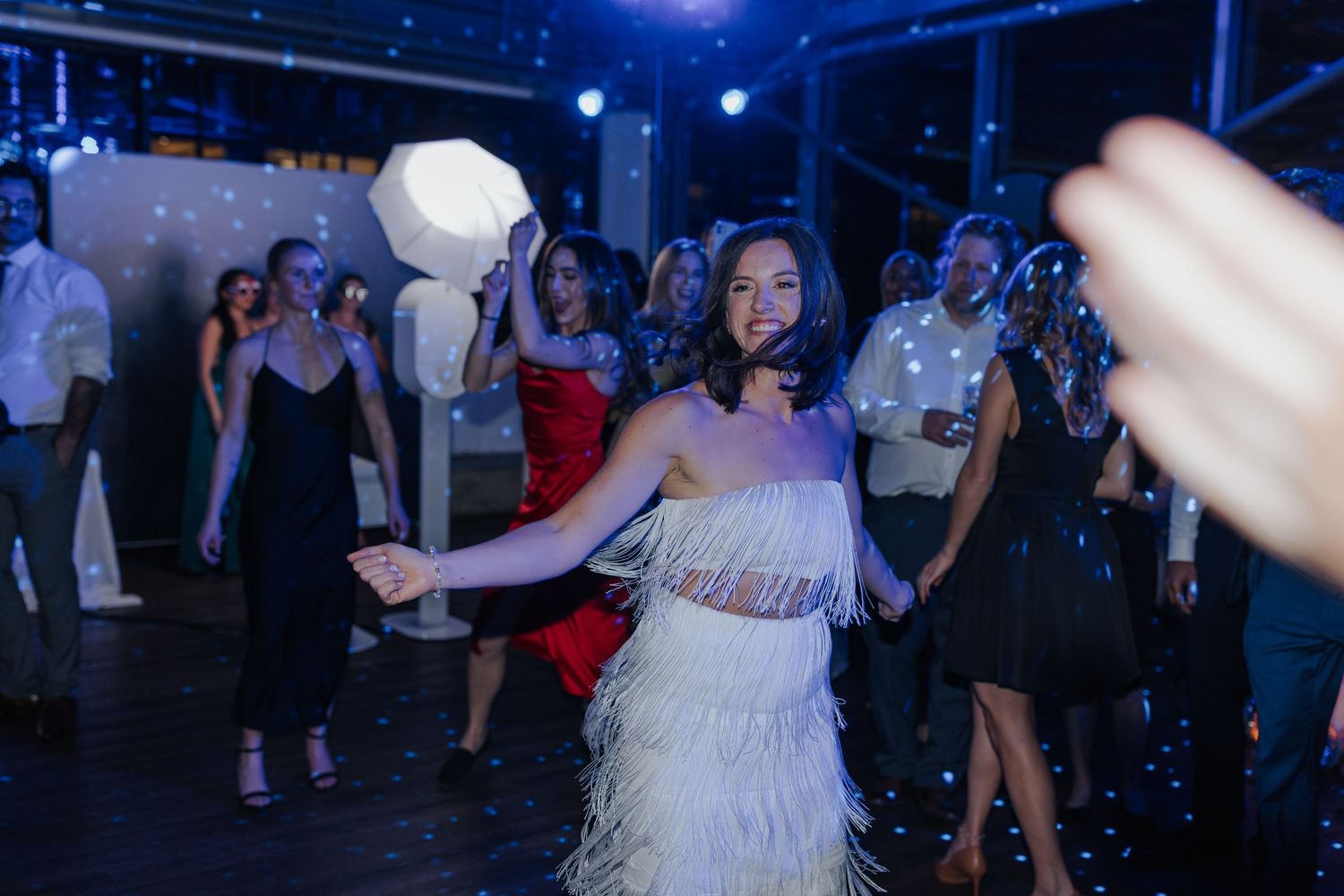 Dance party scene with blue lighting and disco effects creating an energetic nightclub atmosphere.