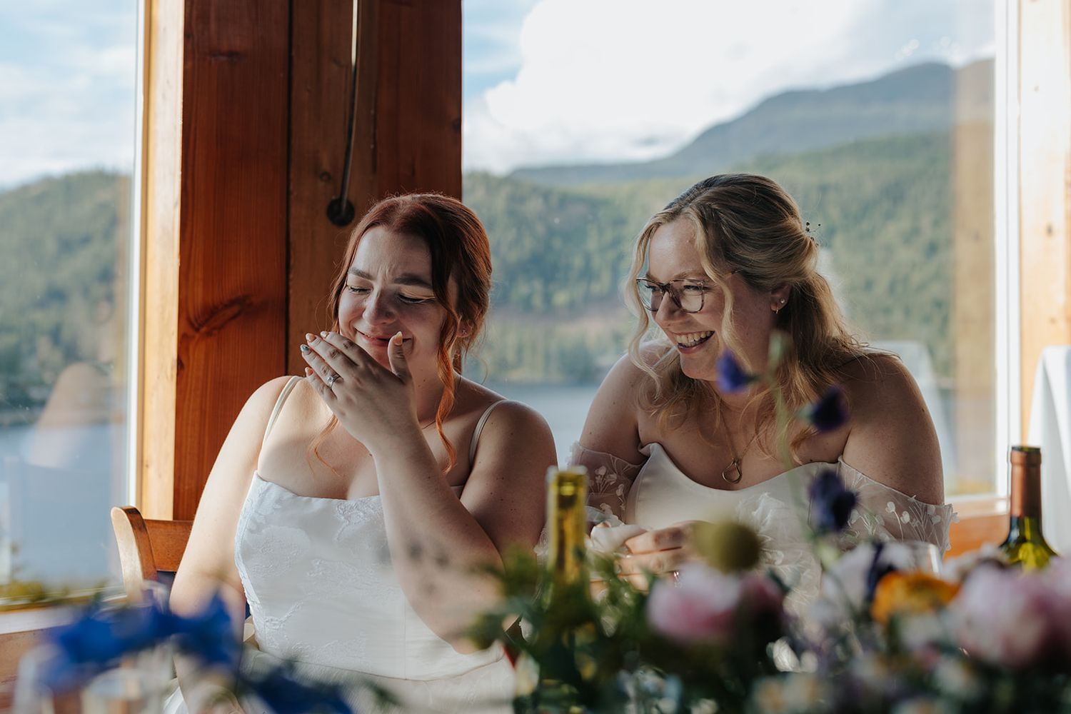 Wedding reception overlooking scenic mountain landscape through large windows.