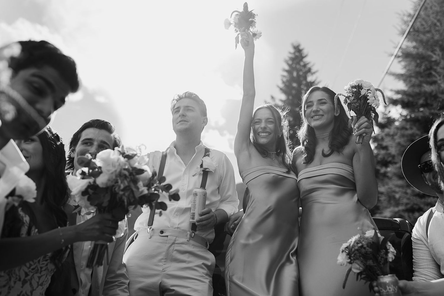 Black and white photo capturing joyful celebration moments at a wedding reception.