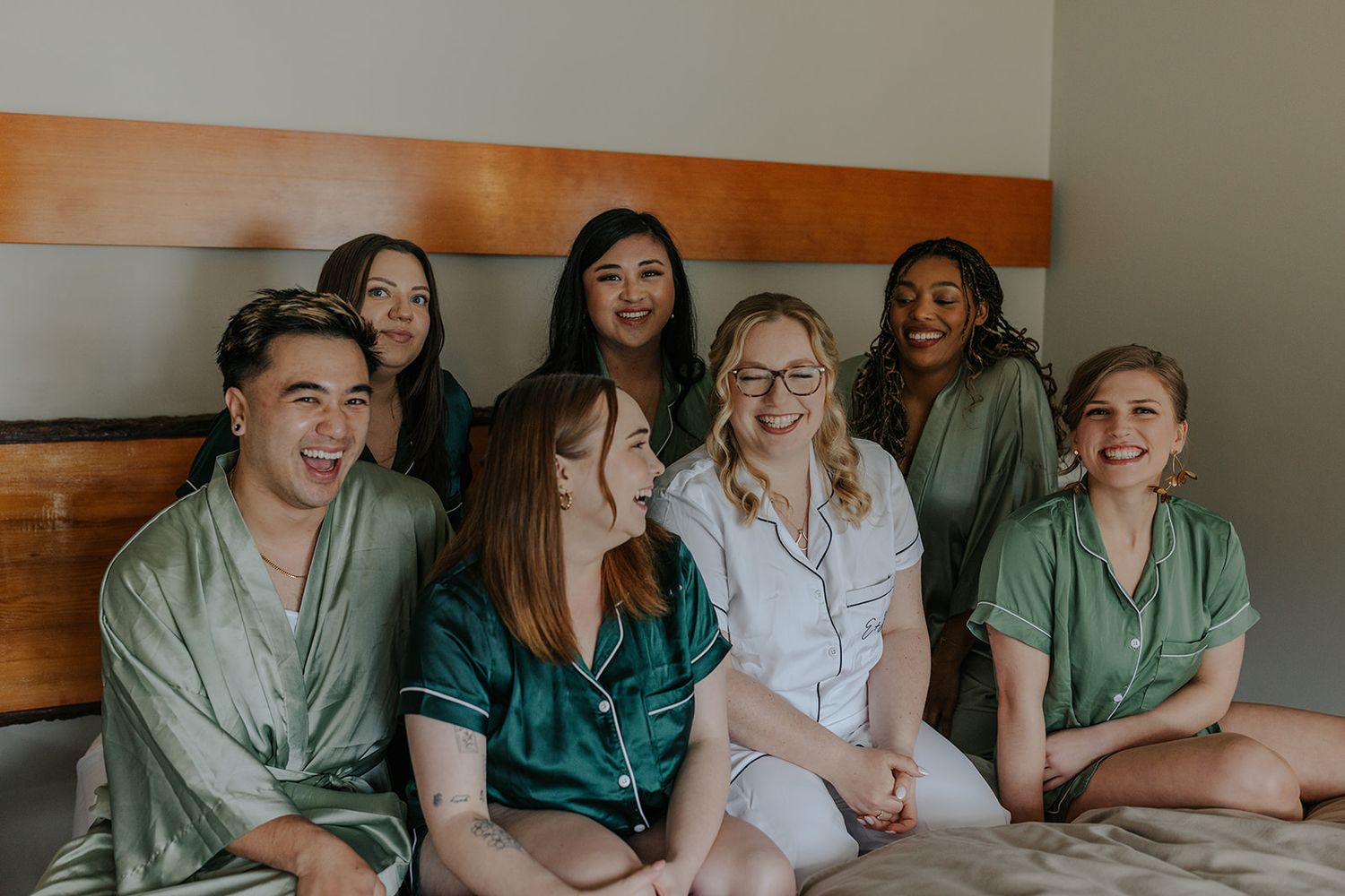 Group photo of wedding party members relaxing together in casual attire.