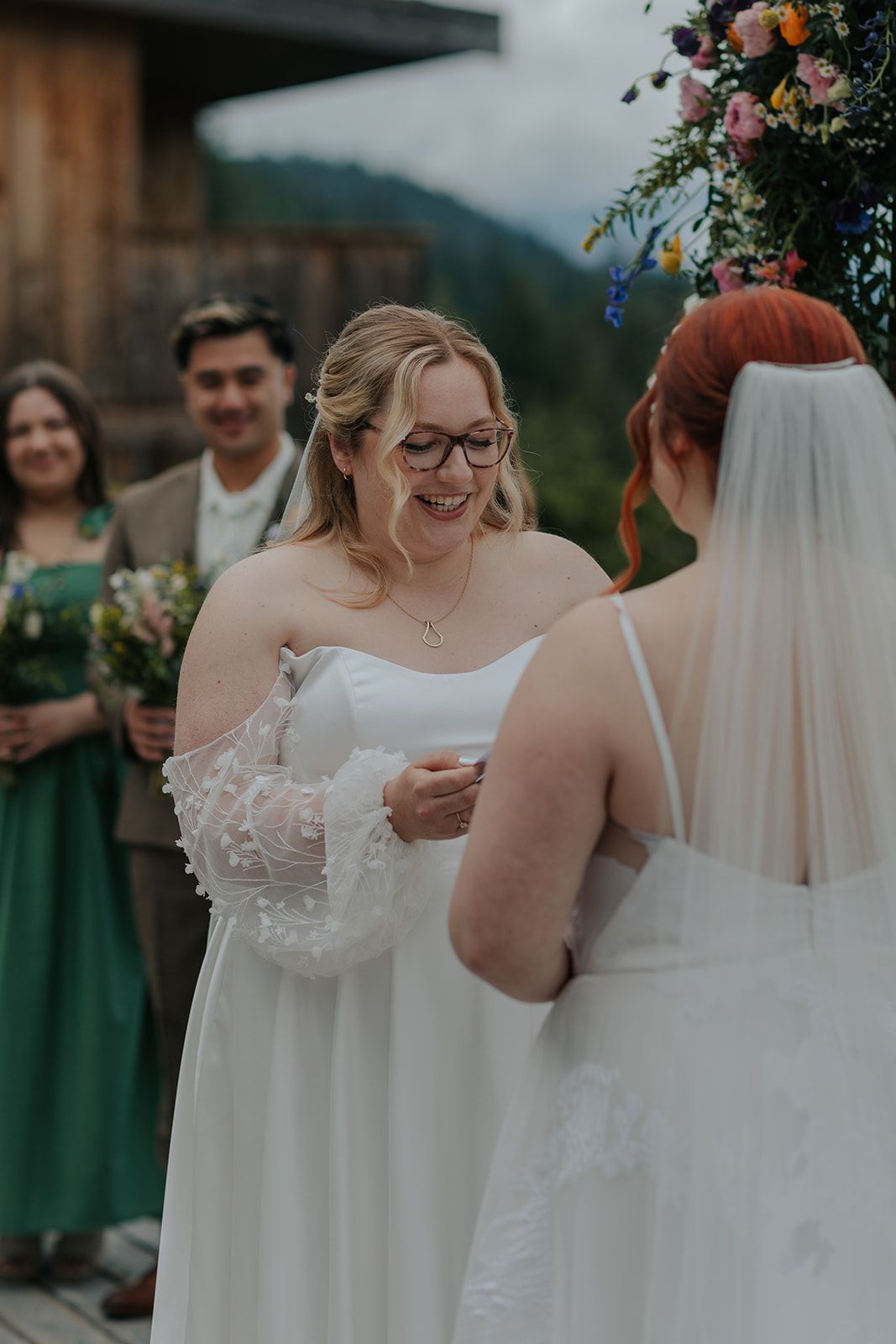 Wedding party members in white and green attire gathered for outdoor celebration.