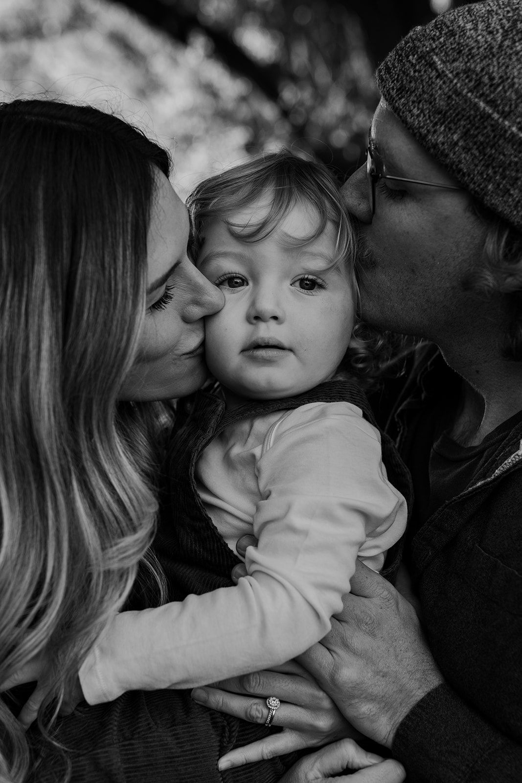 Black and white intimate family portraits showing tender moments of affection and connection.