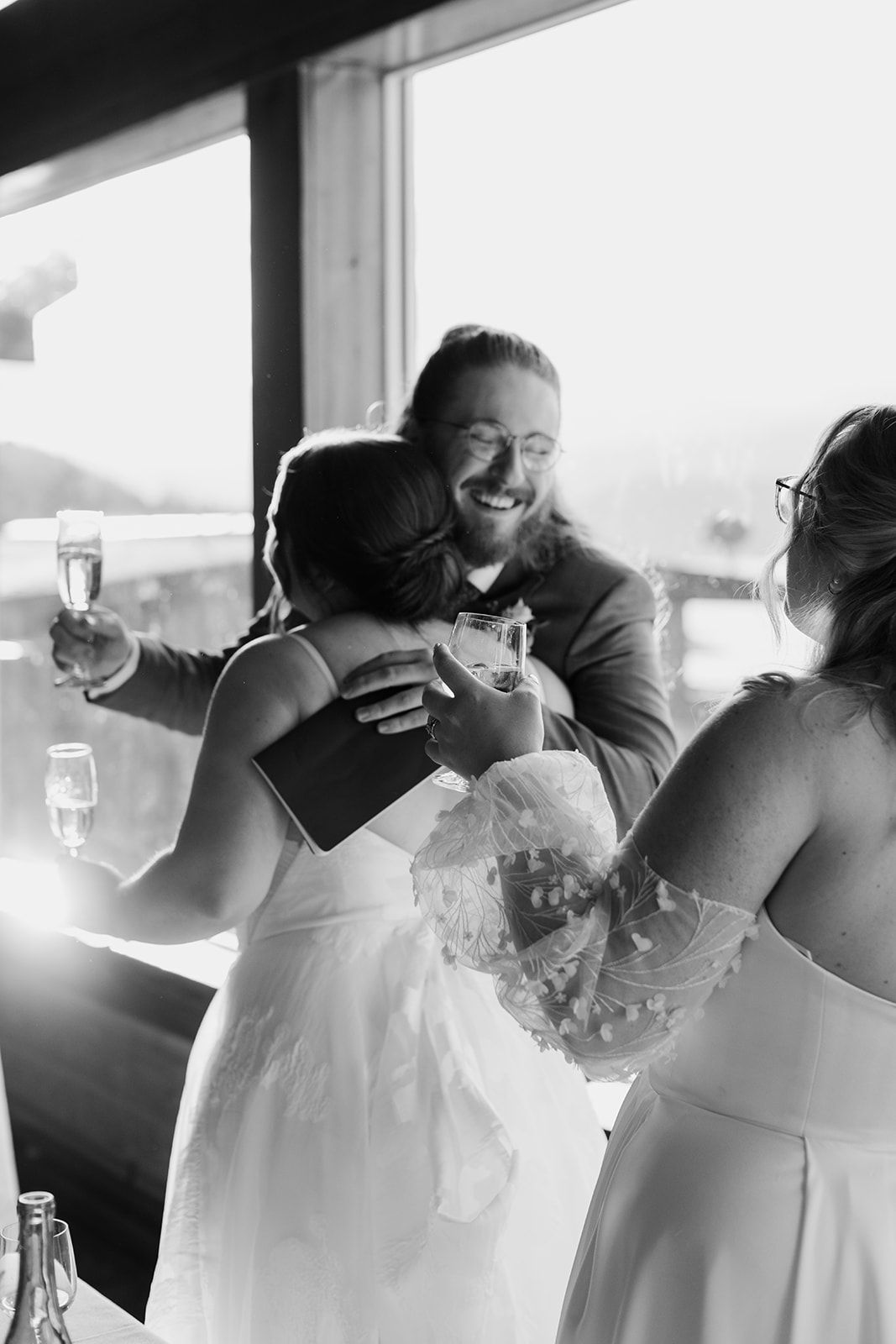 Black and white candid moments of wedding guests during emotional toasts.