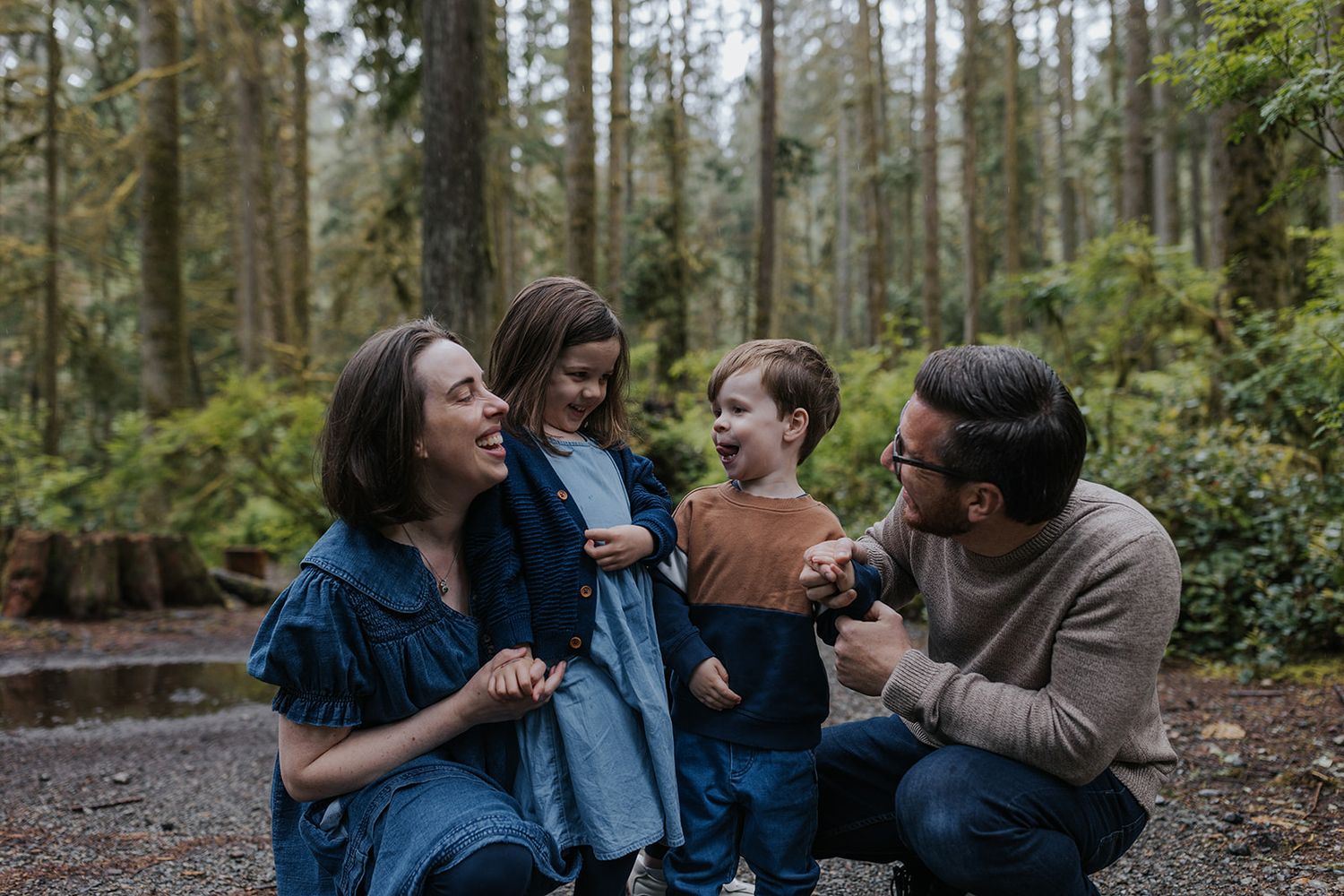 Natural candid family moments photographed in a peaceful forest setting.