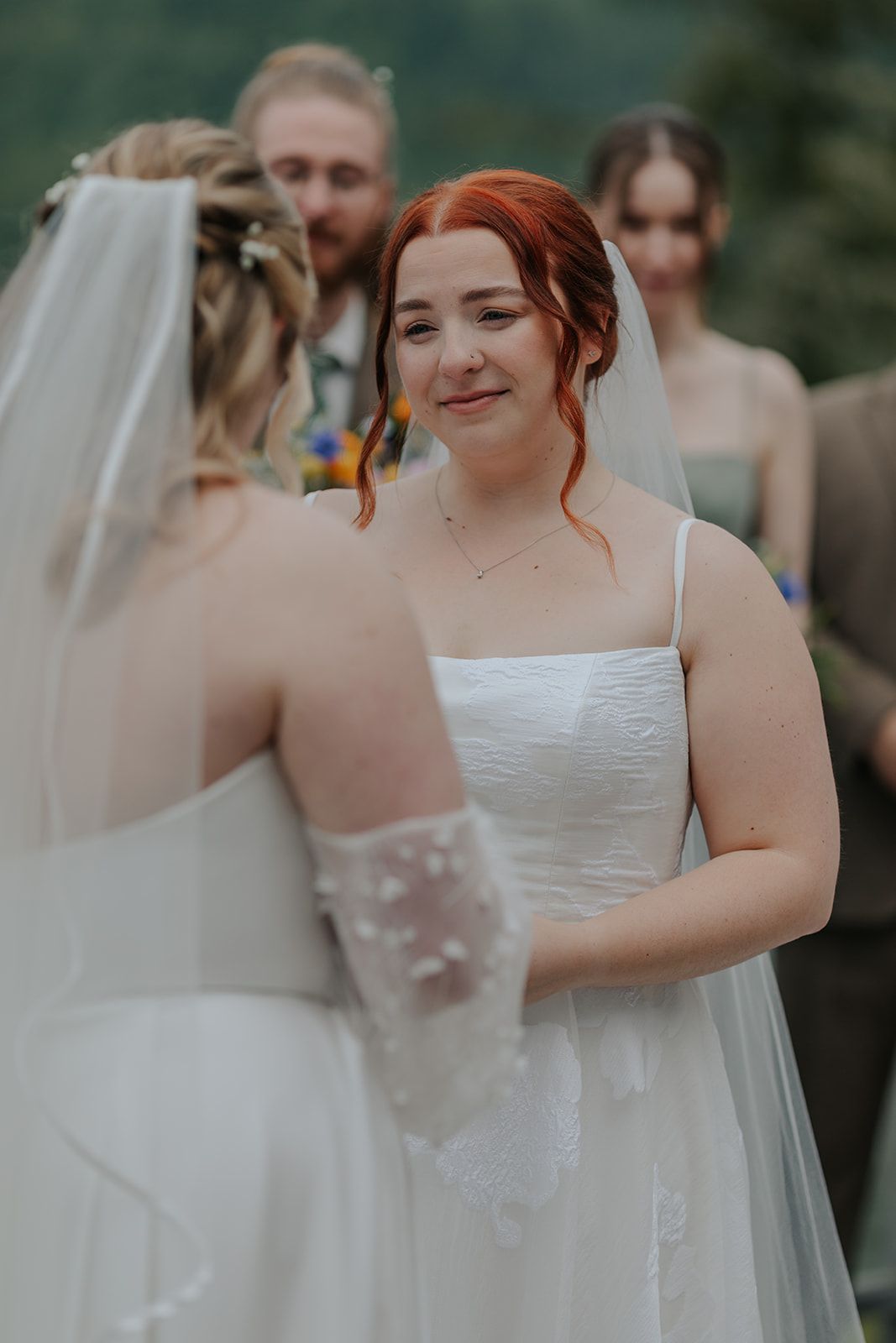 Intimate wedding ceremony moment captured on an outdoor deck with mountain views.