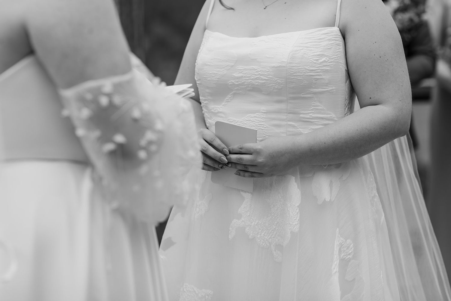Wedding ceremony participants in elegant white dresses gathered on a mountain deck.