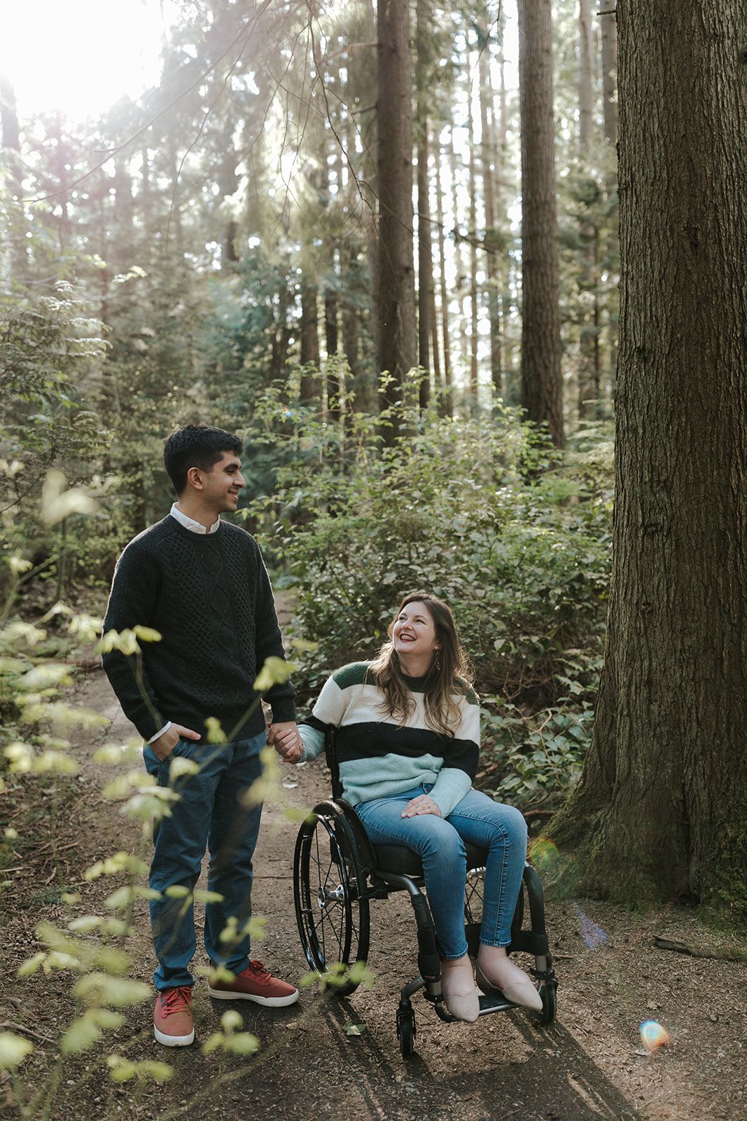 Couple sharing a moment together on a bench in a peaceful forest setting.