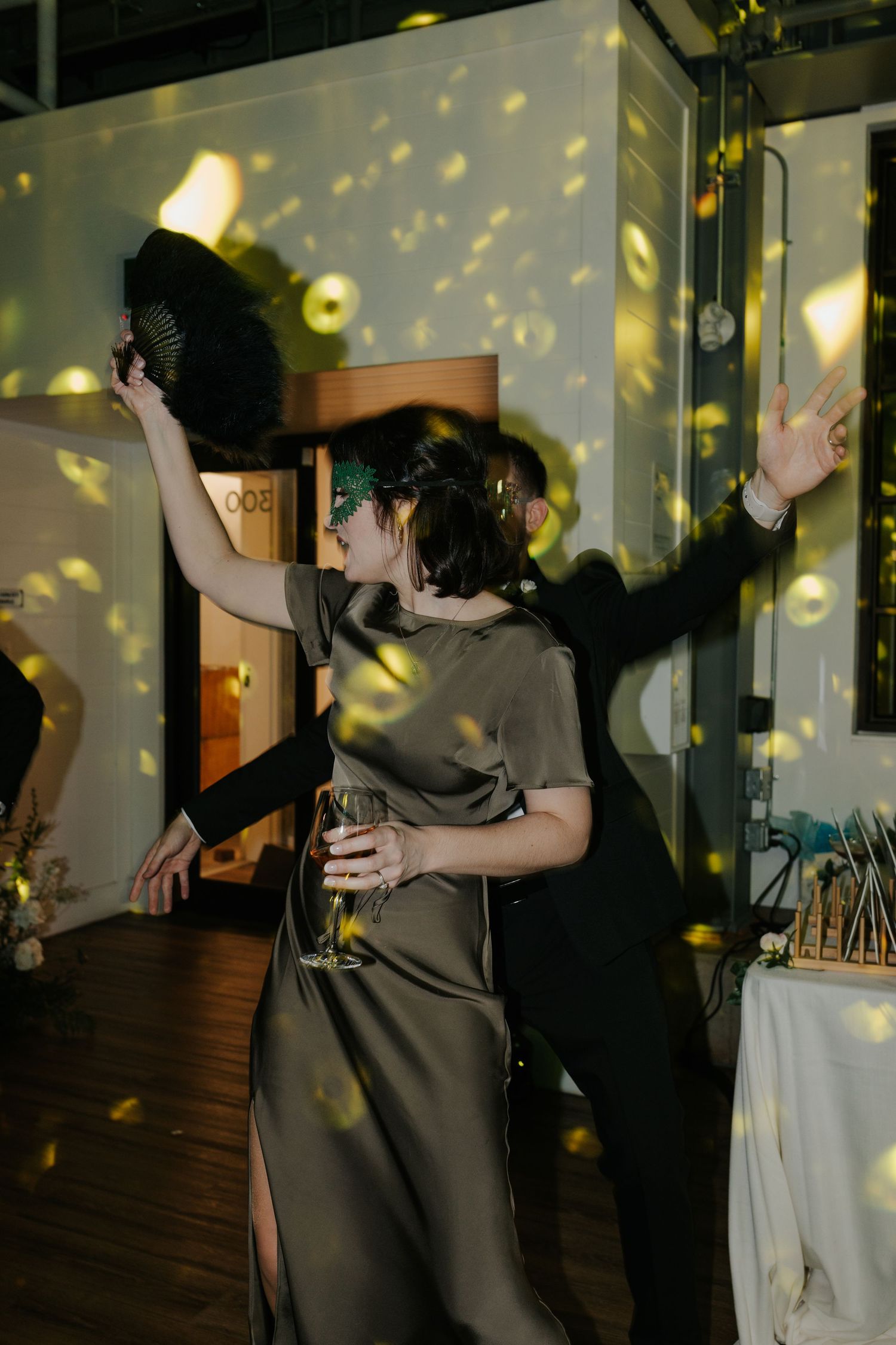 Dance party sequence showing couples dancing under yellow spotlights and disco effects.