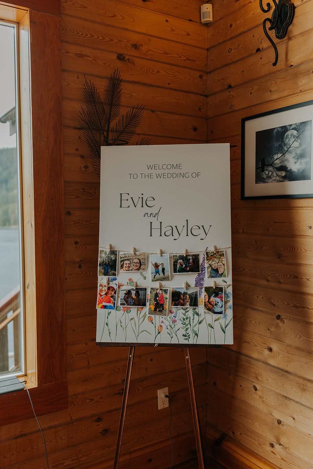 Rustic wooden wall with wedding welcome sign featuring couple's names and photo collage.