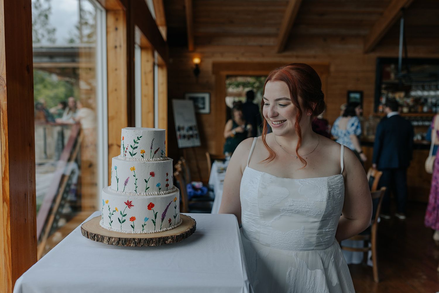 Wedding reception featuring elegant three-tier cake with delicate floral design.