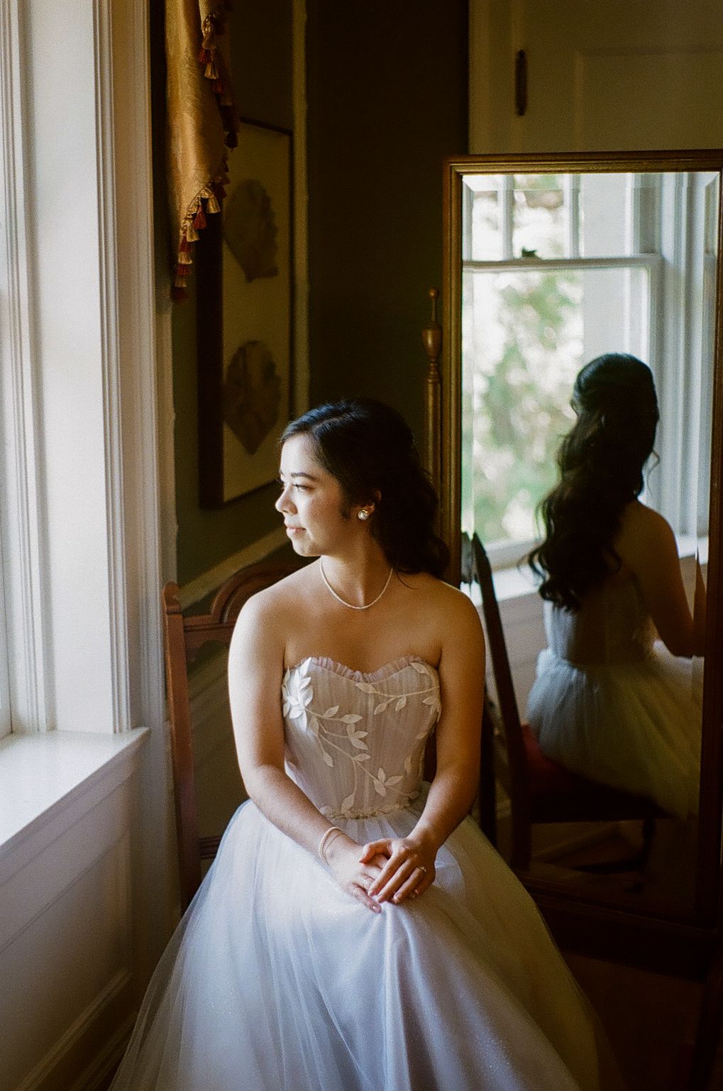 Intimate bridal portrait by a window in soft, dreamy natural light.