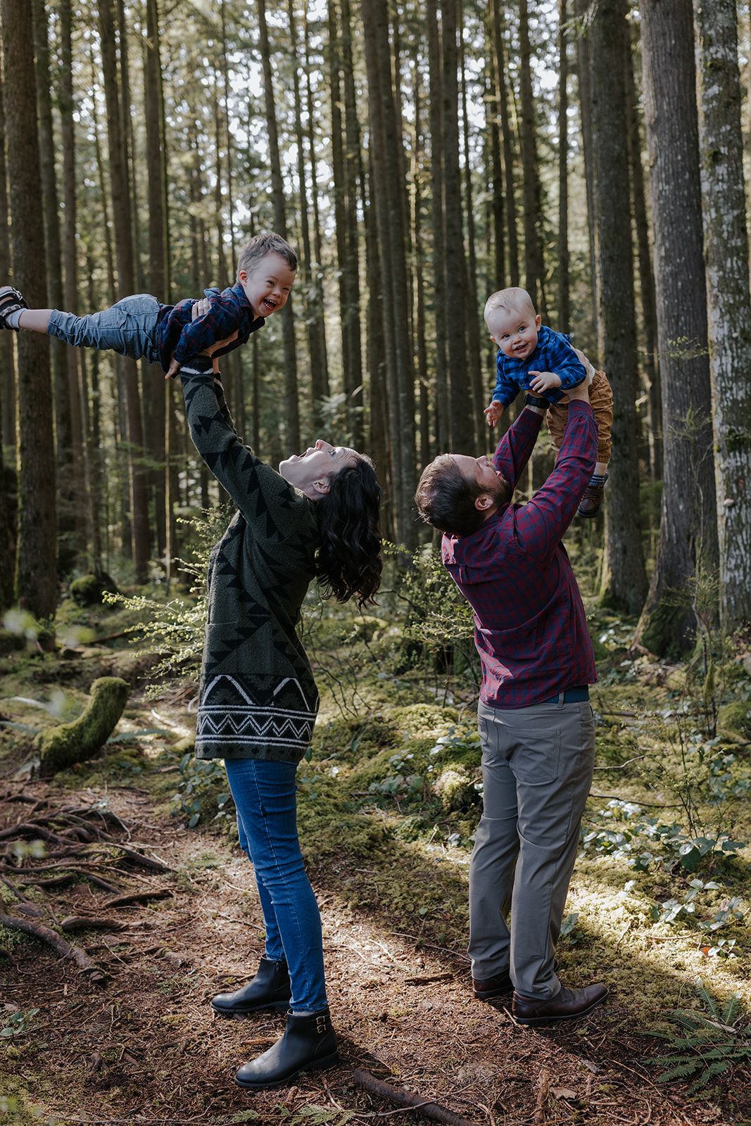 Playful sequence of people dancing and twirling in a sunlit forest with tall evergreen trees.