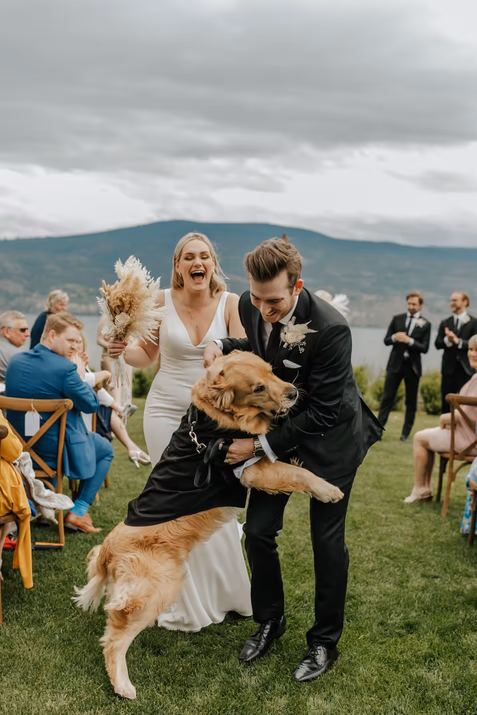 couples dog joins them when exiting the ceremony down the aisle