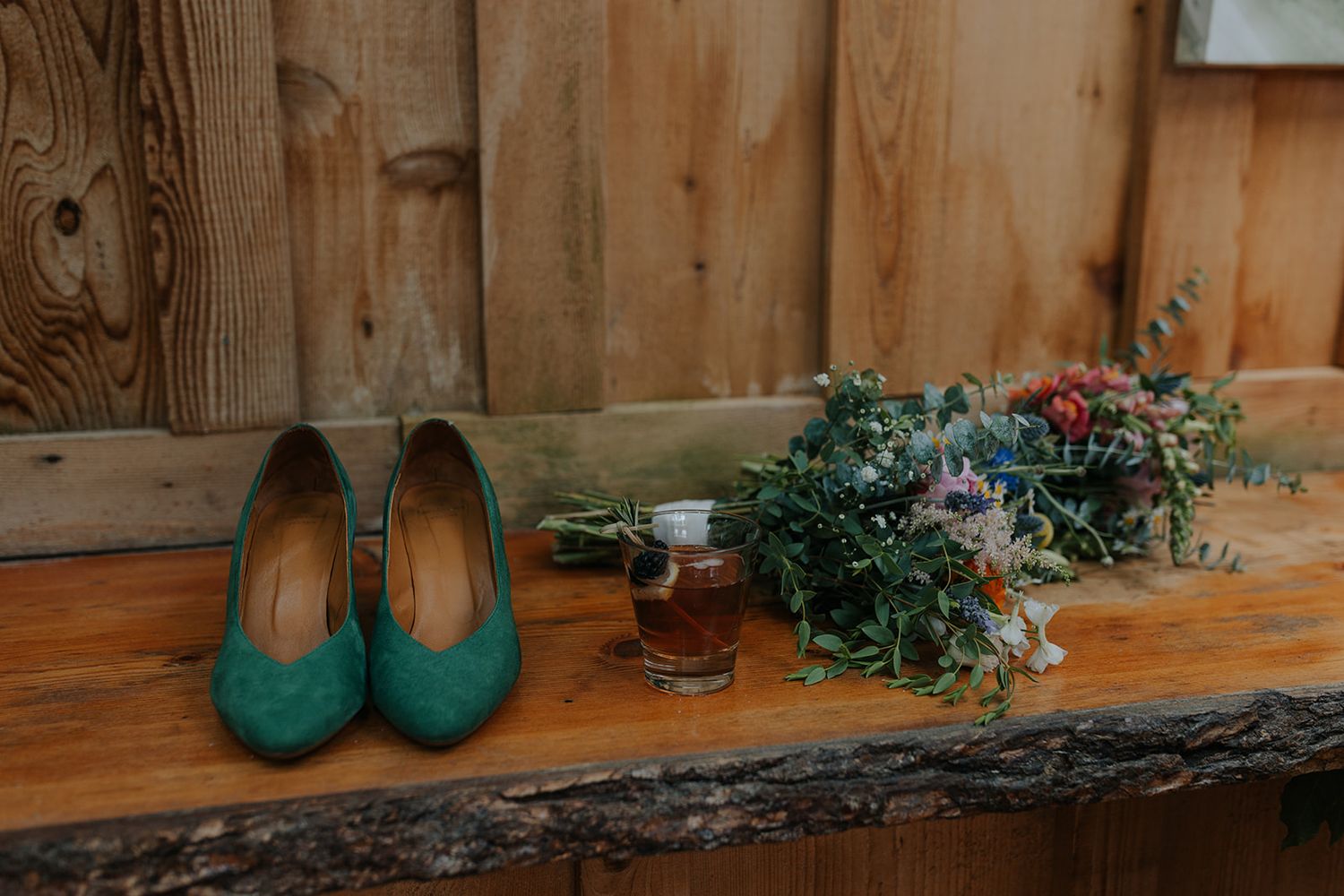 Rustic wooden decor elements with teal shoes and floral arrangements.