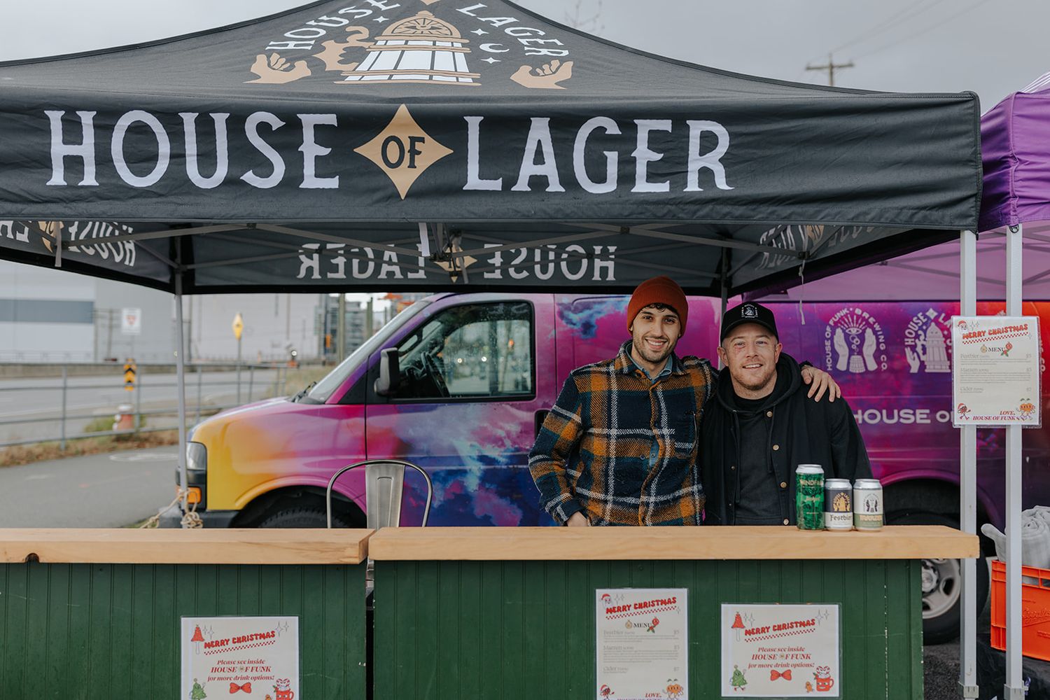 A black tent with 'House of Lager' banner stands at an outdoor event.
