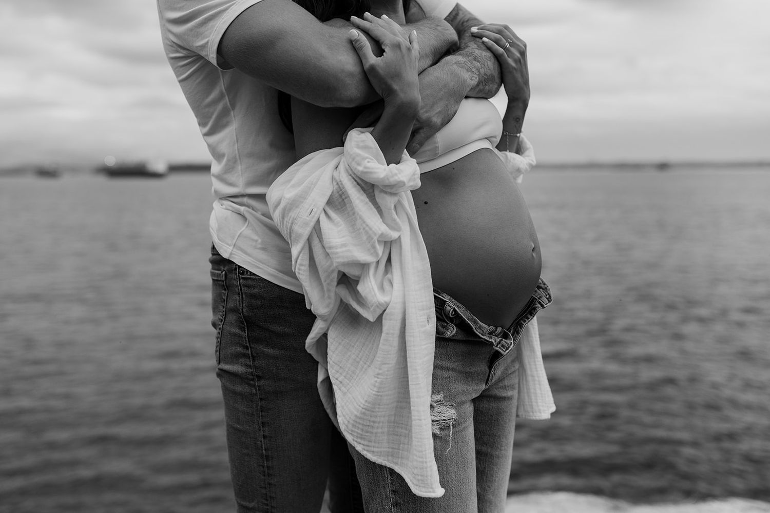 Series of intimate black and white maternity photos by the ocean.