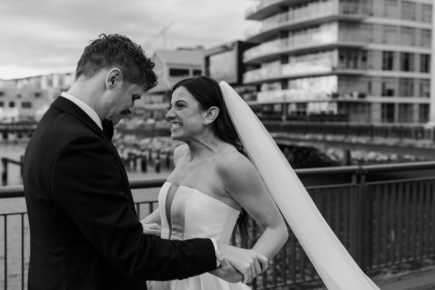 Black and white wedding photos showing romantic moments between newlyweds on a rooftop terrace.