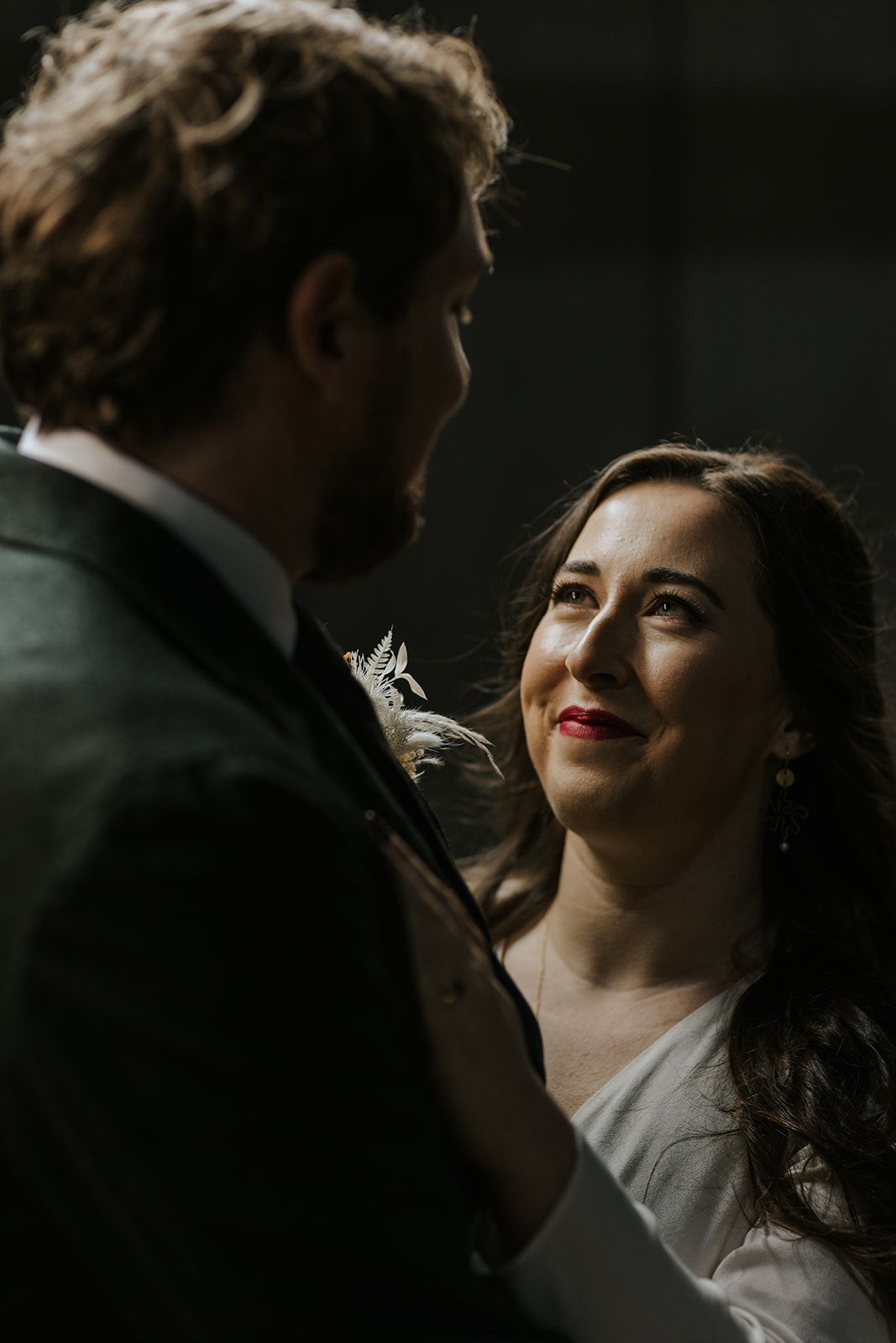 Dramatic low-light portrait with intimate lighting and deep shadows.