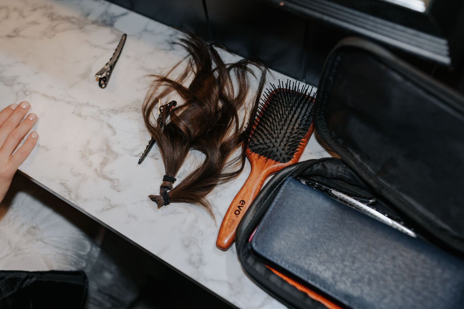 Orange heels and formal attire details captured on a light colored surface.