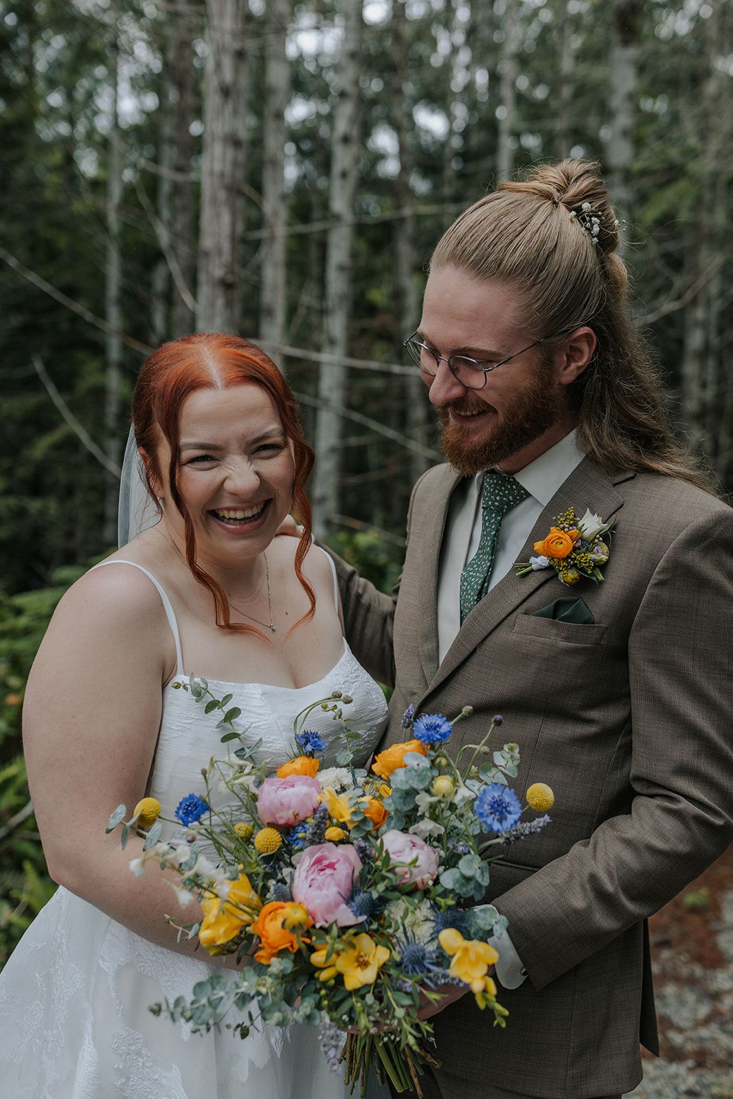 Candid moments captured during a forest wedding ceremony with bright floral arrangements.