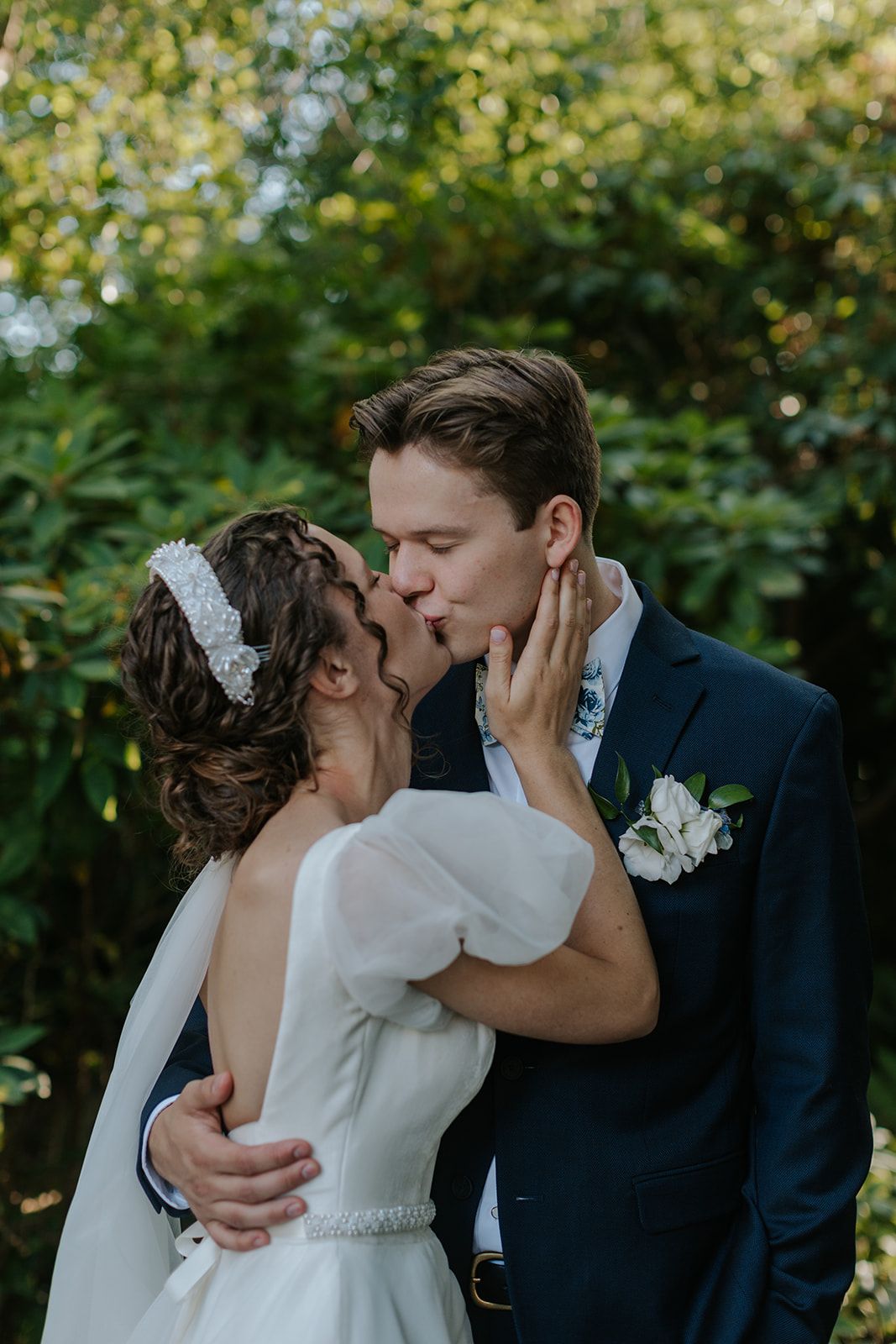 A romantic sequence of wedding photos showing a couple sharing their first kiss in a garden setting.