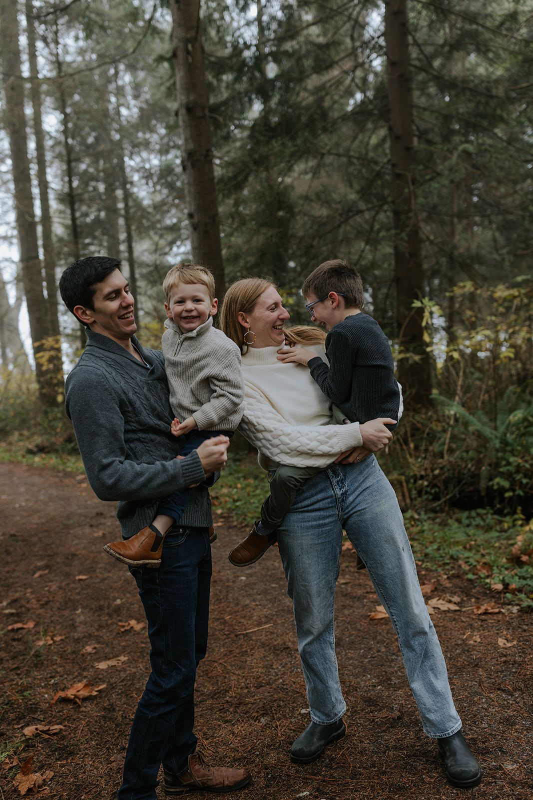 A playful sequence of people dancing and laughing together in a forest setting.