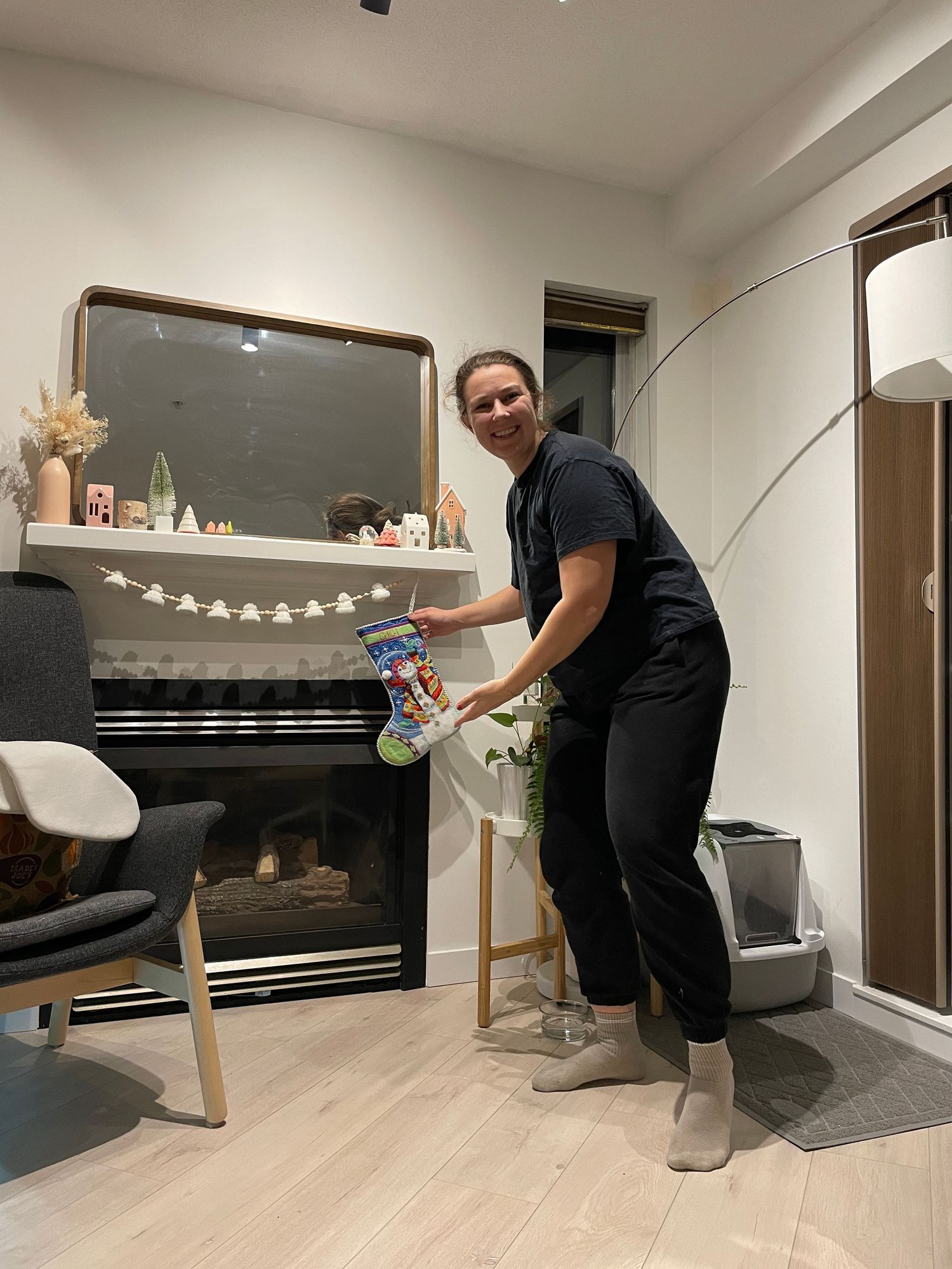 A person cleaning and organizing items in a modern living room.