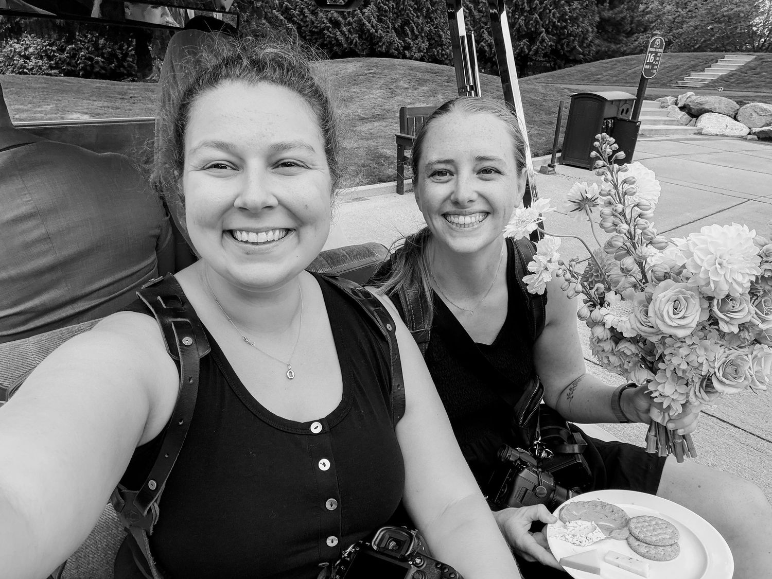Friends enjoying a casual outdoor gathering with flowers and food.