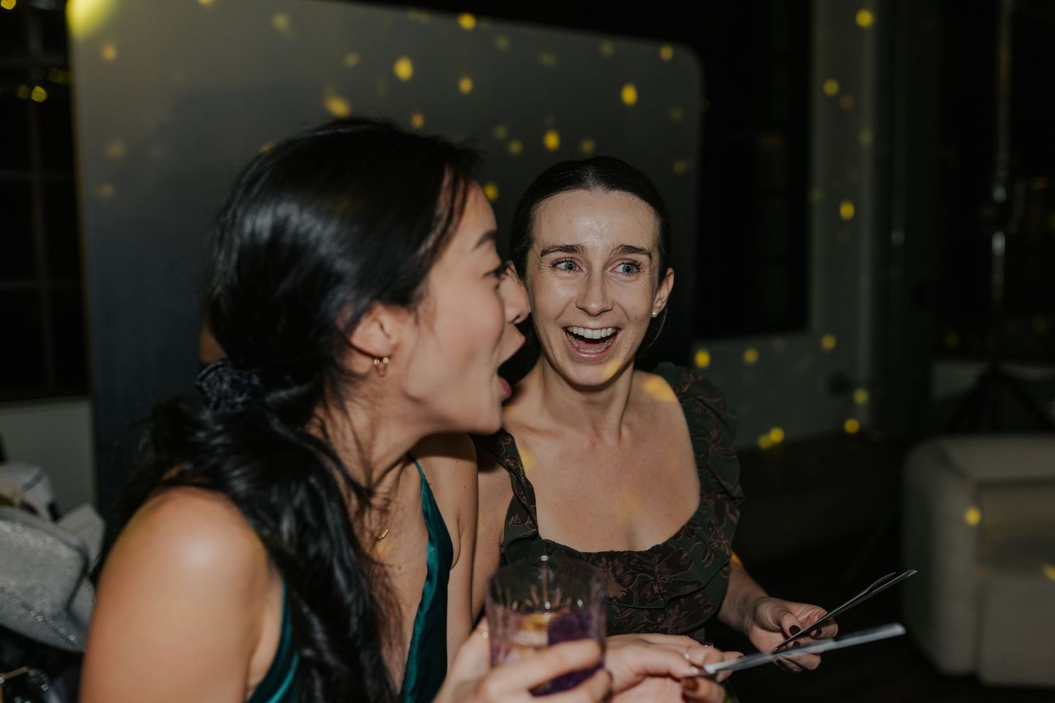 Candid nighttime celebration moments captured with warm ambient lighting.
