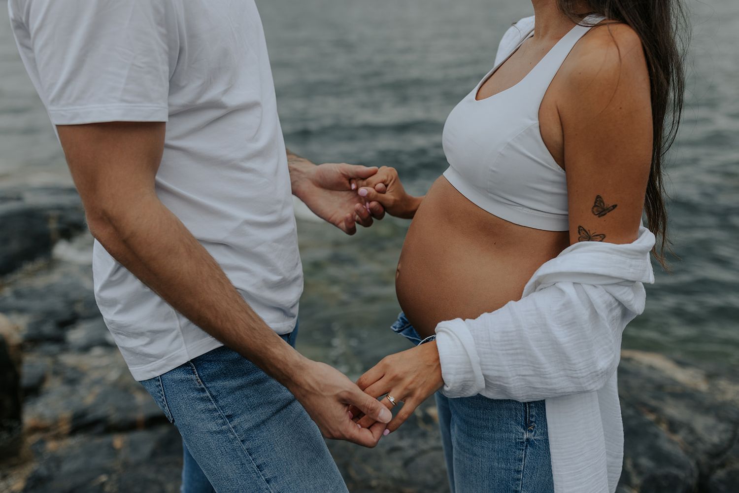 Close-up shots of couple in casual attire standing together by water's edge.