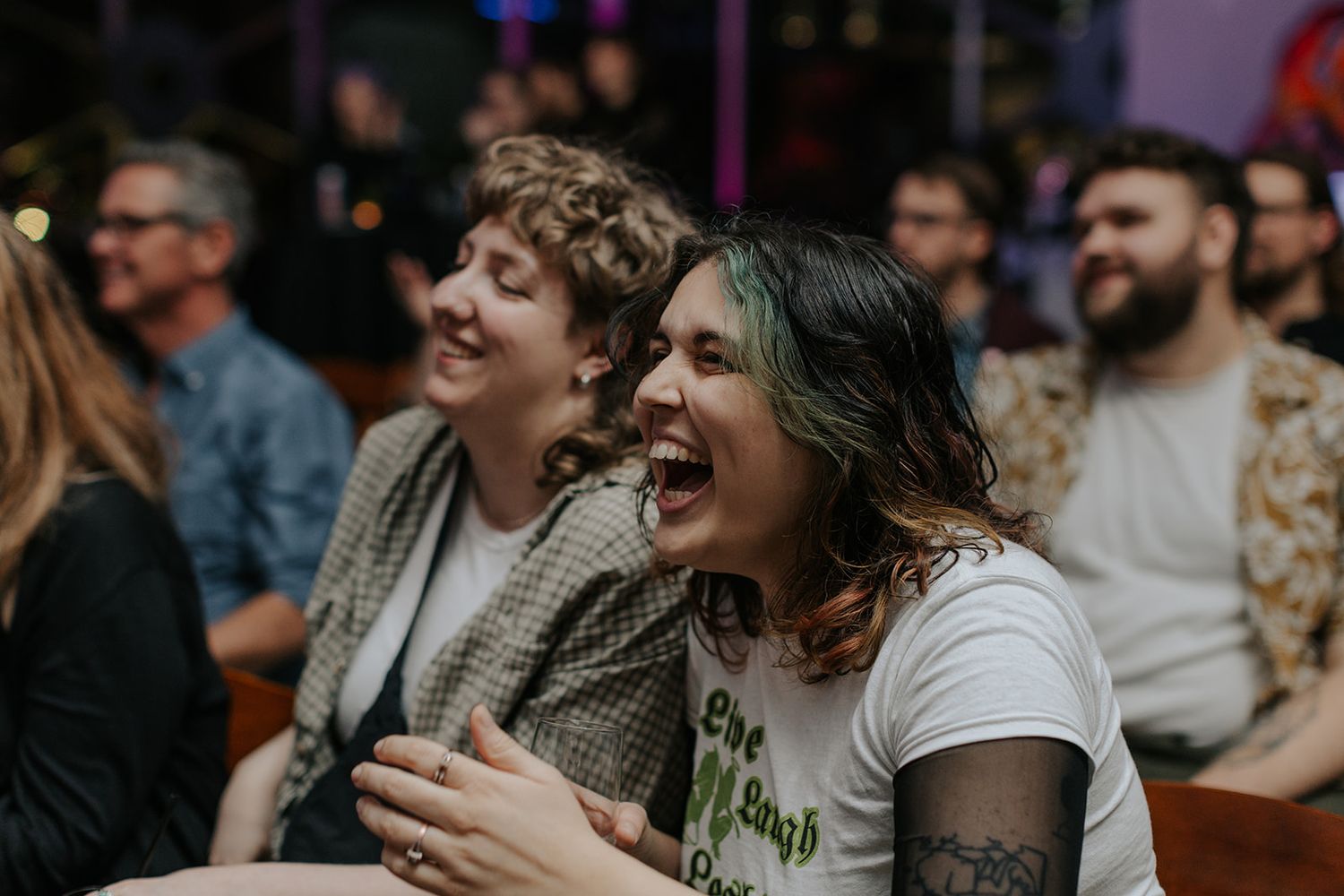 Audience members react with laughter during an entertainment show.