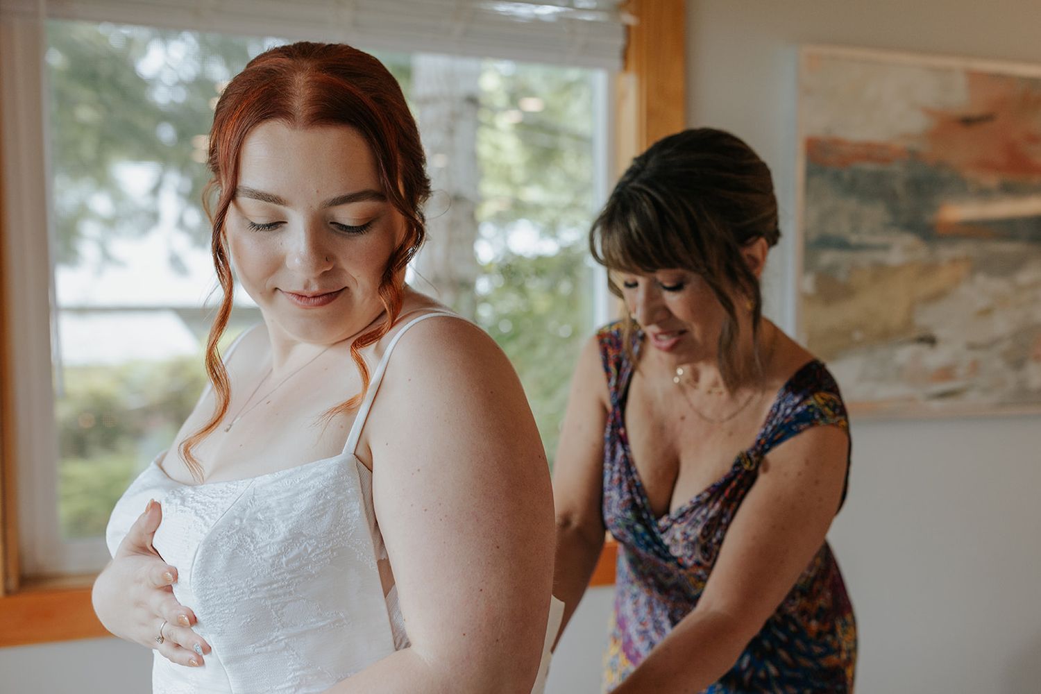 Wedding dress preparation scene with delicate lace details being adjusted.