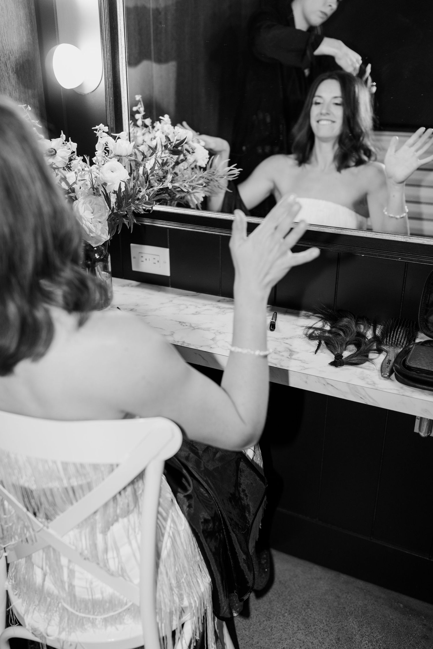 Black and white sequence showing preparation moments in front of a mirror.
