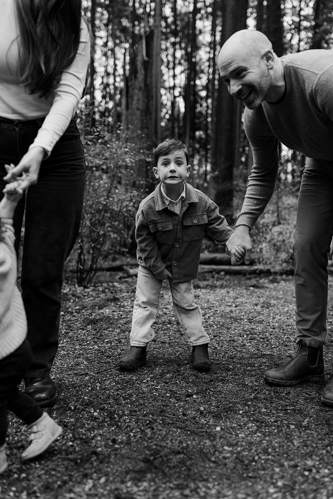 Black and white sequence showing playful interactions in a forest setting.