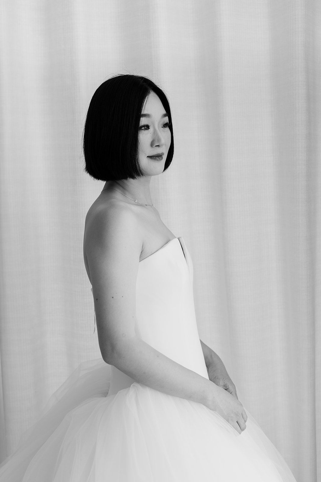 Artistic black and white bridal portraits showcase an elegant ball gown wedding dress.