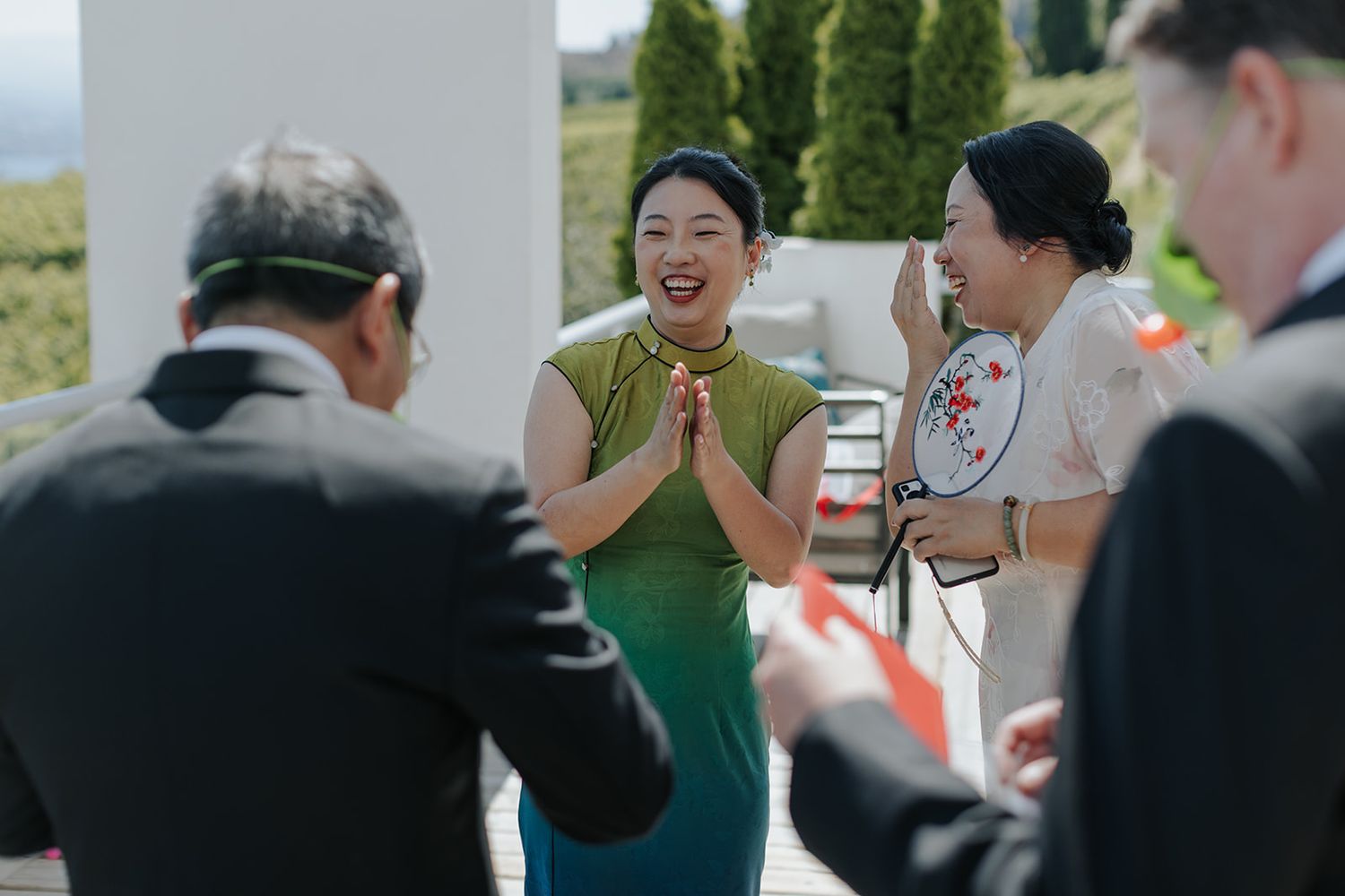 Wedding guests applauding during reception celebration.