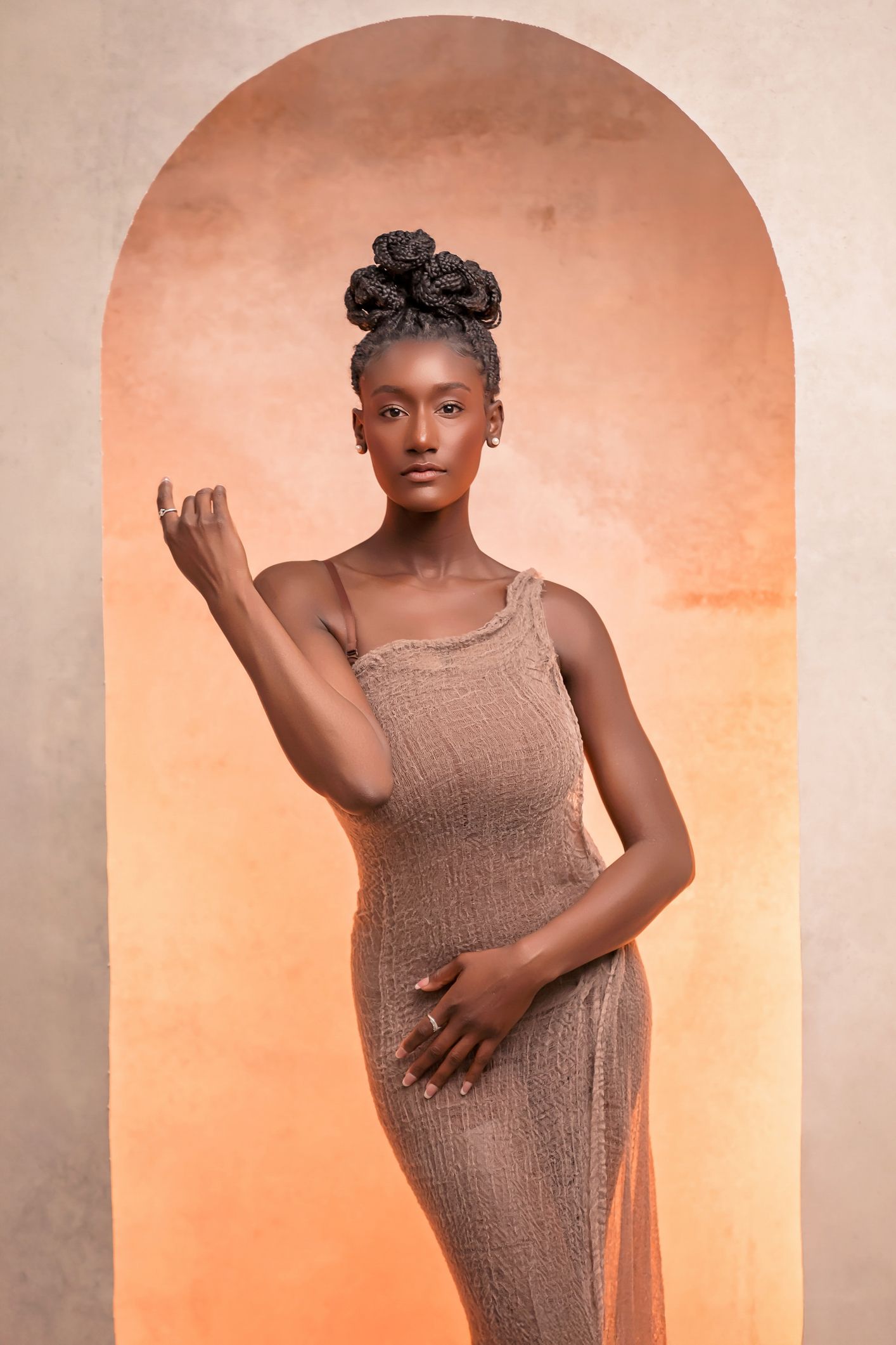 Elegant female portrait photography sequence showing expressive movements in soft orange lighting.